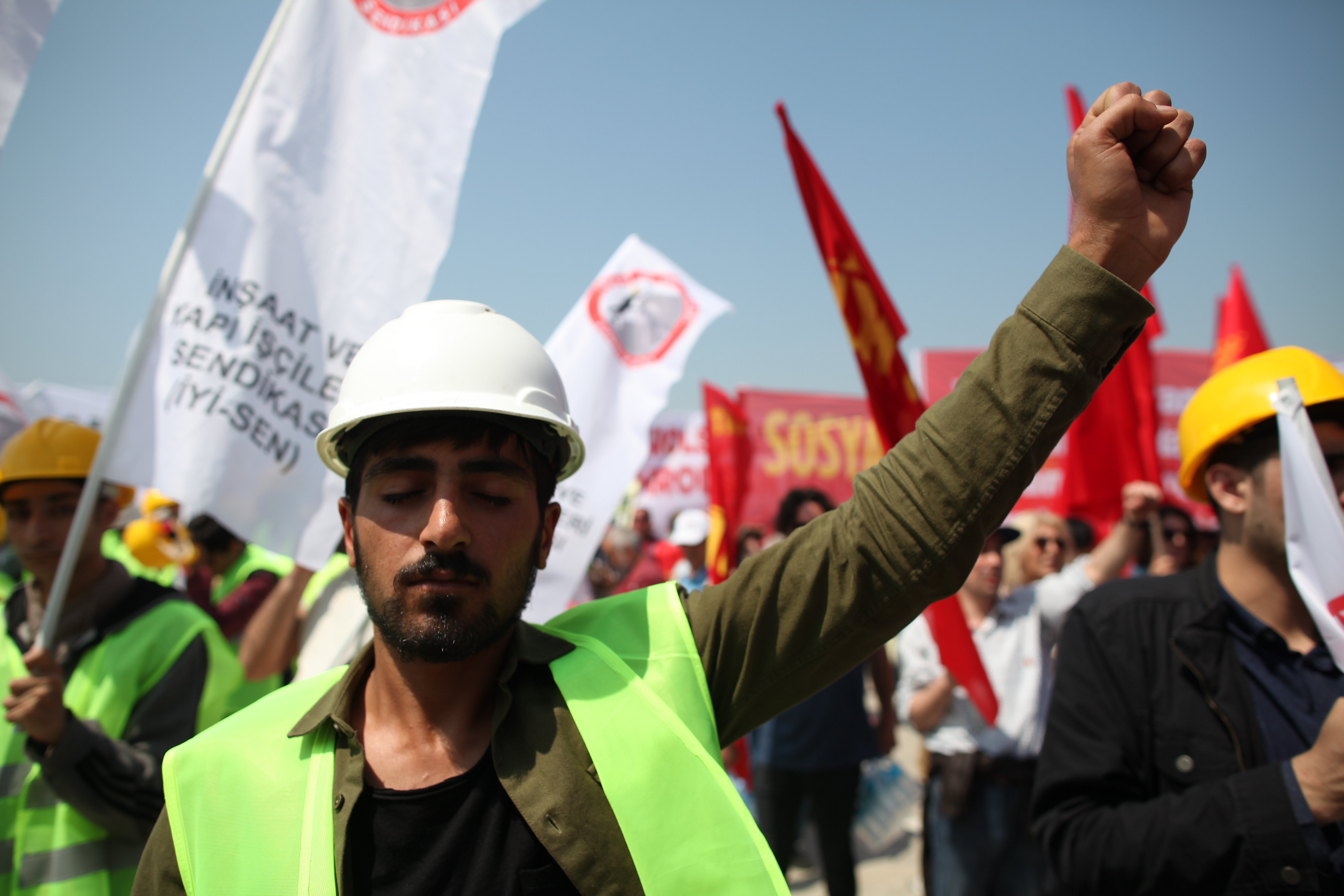 epa06704430 A man raises his fist during a May Day celebration in Istanbul, Turkey, 01 May 2018. Labor Day or May Day is observed all over the world on the first day of May to celebrate the economic and social achievements of workers and fight for laborers rights.  EPA/CEM TURKEL