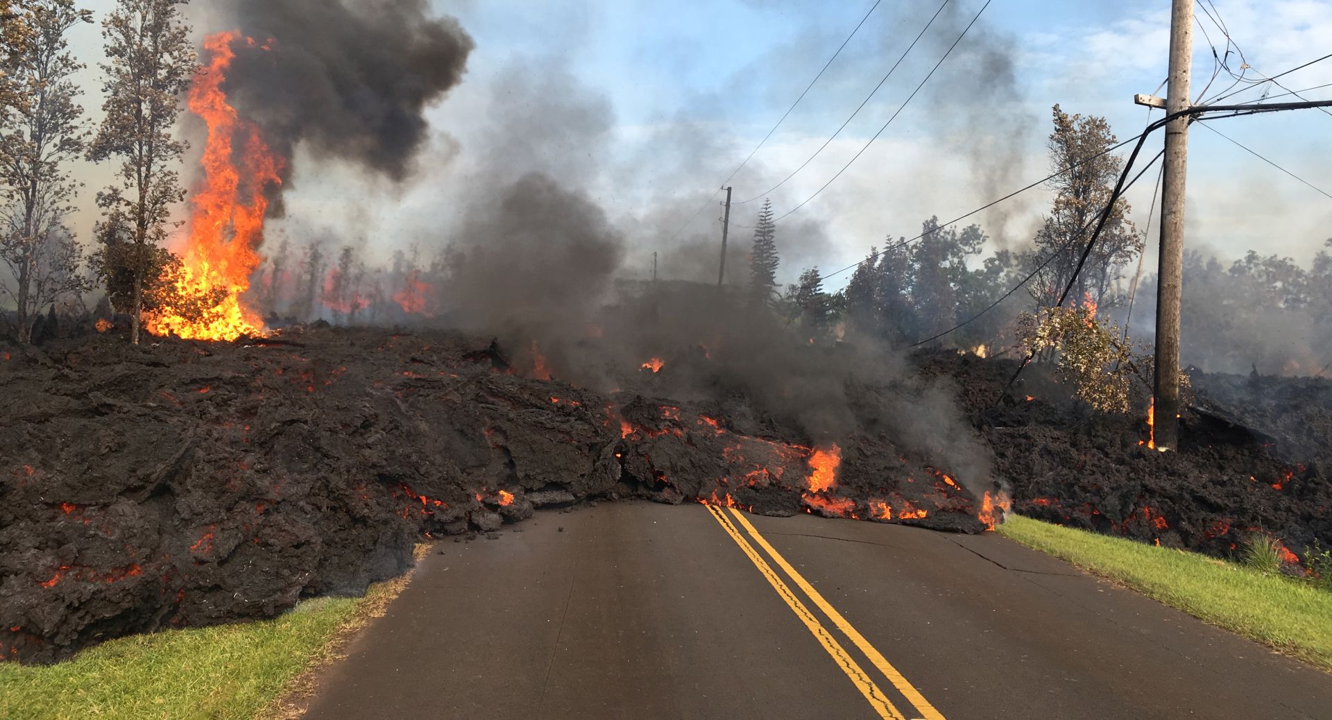 epa06715783 A handout photo made available by the United States Geological Survey shows lava from a fissure slowly advanced to the northeast on Hookapu Street in Leilani Estates subdivision on KÄ«lauea Volcano's lower East Rift Zone near Pahoa, Hawaii, USA, 05 May 2018 (issued 06 May 2018). A local state of emergency has been declared after Mount Kilauea erupted near residential areas, forcing mandatory evacuation of about 1,700 citizens from their nearby homes. The crater's floor collapsed on 01 May and is since then continuing to erode its walls and generating huge explosions of ashes. Several earthquakes have been recorded in the area where the volcanic eruptions continue, including a 6.9 magnitue earthquake which struck the area on 04 May.  EPA/USGS HANDOUT  HANDOUT EDITORIAL USE ONLY/NO SALES
