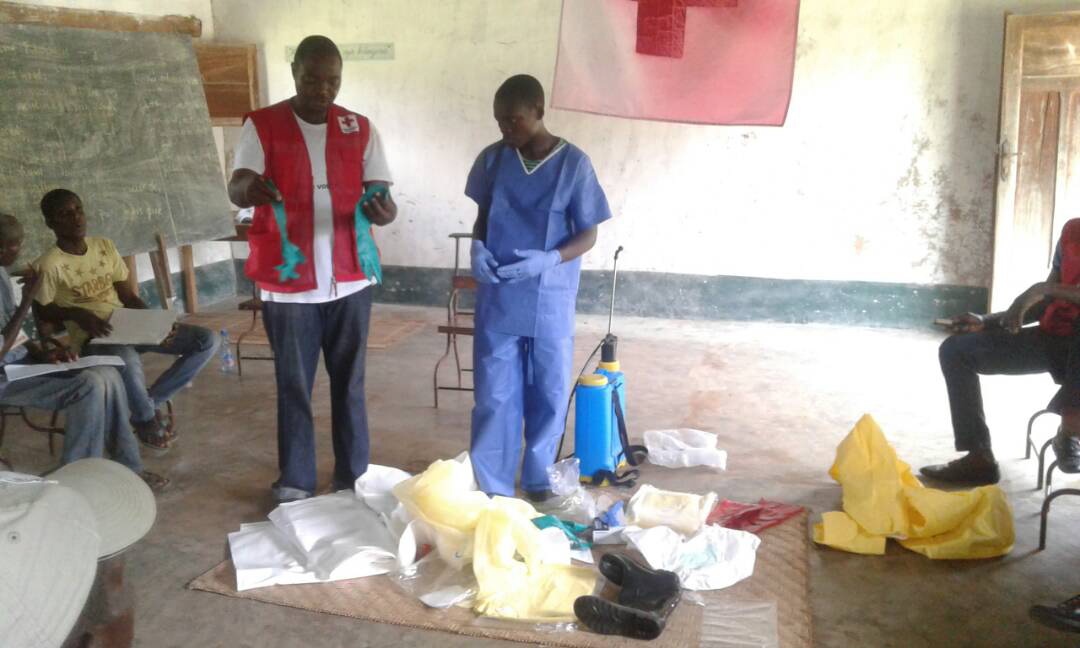 epa06754180 A handout photo made available by The International Federation of Red Cross and Red Crescent (IFRC) shows health workers putting on protective clothing in Bikoro, the epicenter of the latest Ebola outbreak, in The Democratic Republic Of The Congo, 17 May 2018 (issued 21 May 2018). According to media reports, DR Congo authorities are to begin distributing an experimental vaccine in the fight to contain the current outbreak of Ebola in the country. The World Health Organisation (WHO) has not declared the recent outbreak of Ebola in the Democratic Republic of Congo (DRC) a global health emergency but has issued a statement 18 May 2018 that the risk of spread is 'very high'.  EPA/IFRC HANDOUT  HANDOUT EDITORIAL USE ONLY/NO SALES