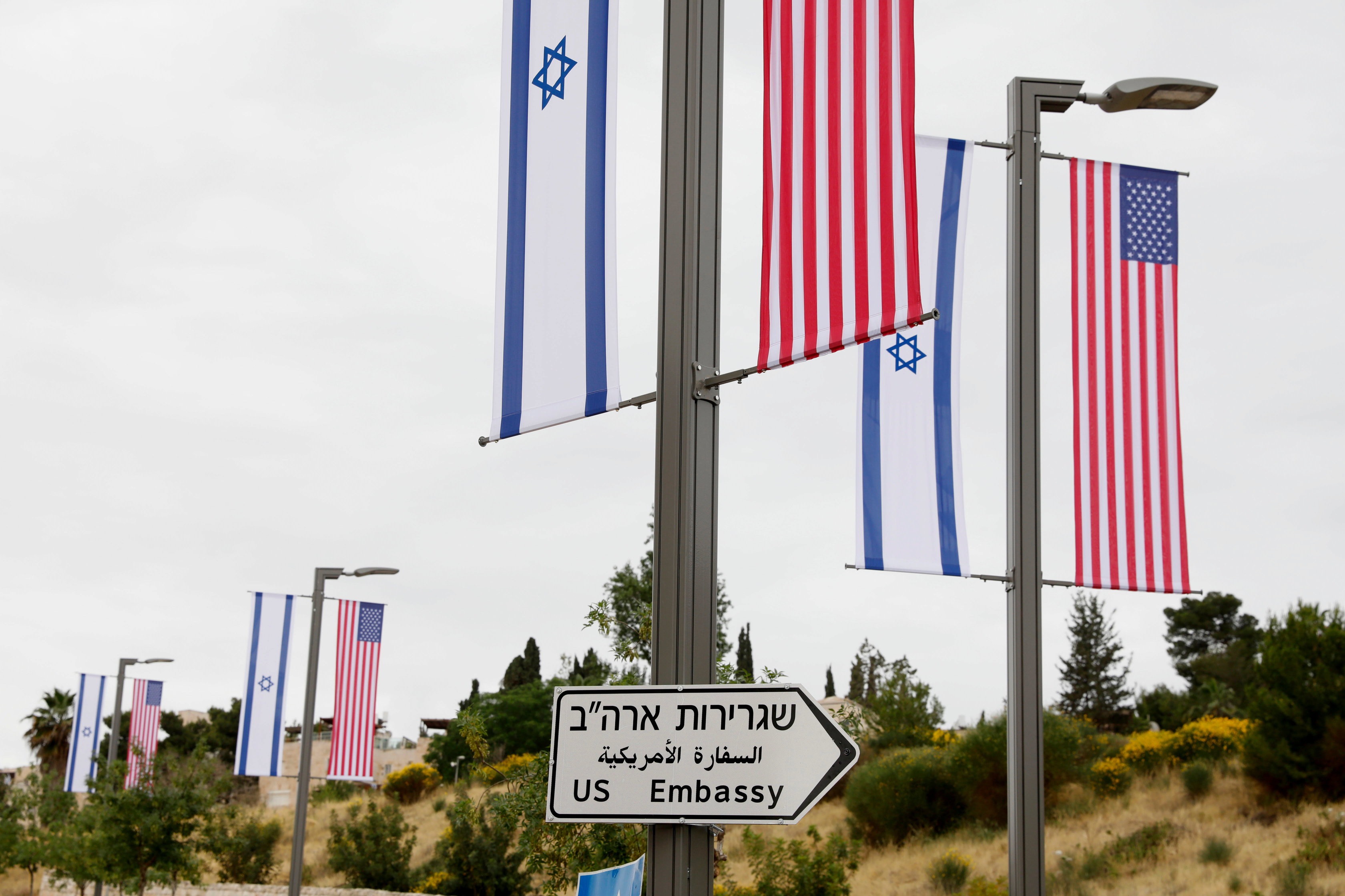 epa06718506 A new road sign and flags are placed at the road leading to the US consulate in the Jewish neighborhood of Arnona on the East-West Jerusalem line in Jerusalem, Israel, 08 May 2018. Media reports that Trump's administration will officially transfer the ambassador's offices to the consulate building and temporarily use it as the new US Embassy in Jerusalem as of 14 May 2018. Trump in December last year recognized Jerusalem as Israel's capital and announced an embassy move from Tel Aviv, prompting protests in the occupied Palestinian territories and several Muslim-majority countries.  EPA/ABIR SULTAN