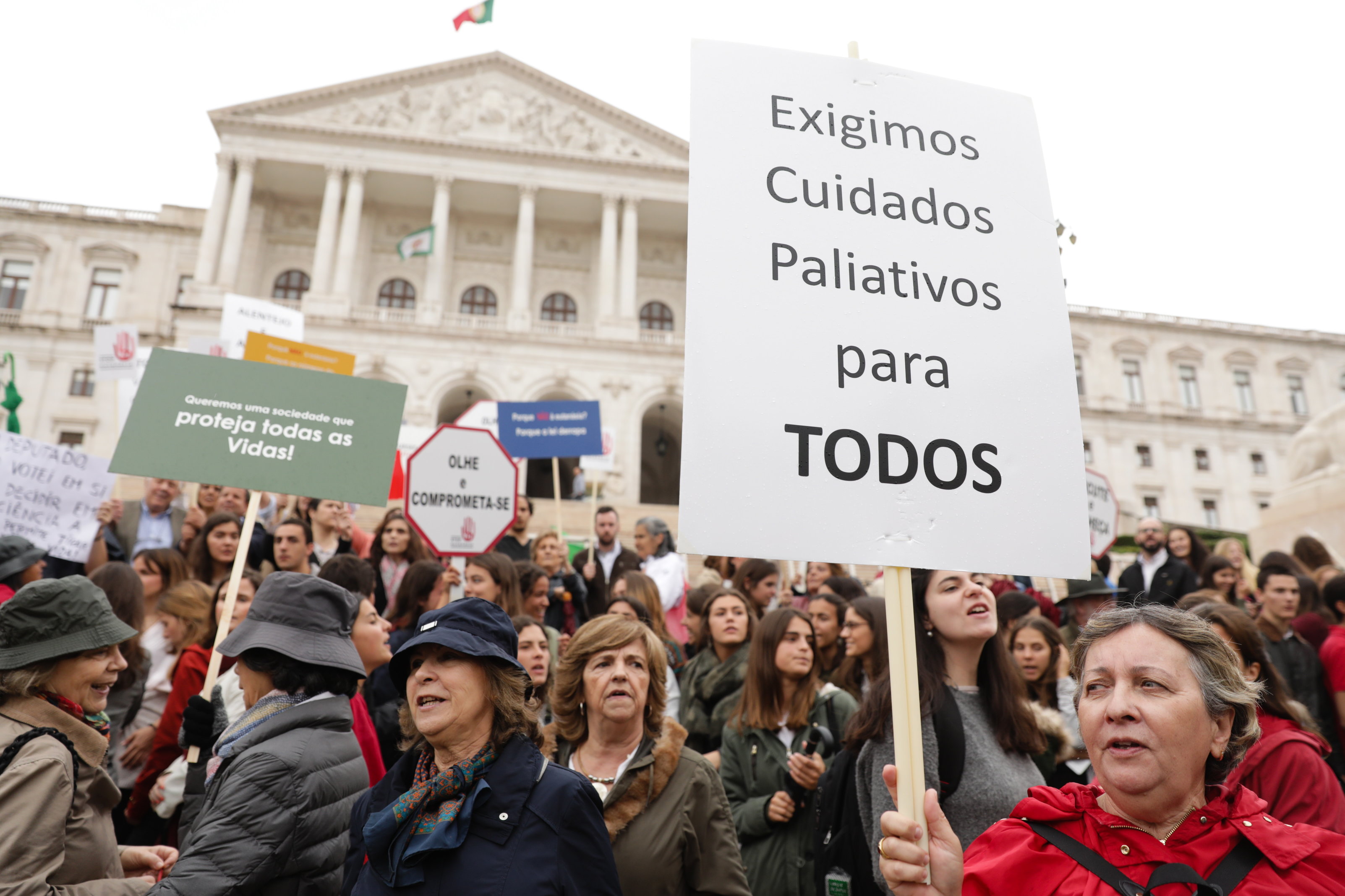 epa06760068 A participant hold a banner with the words 'We Demand Palliative Care For Everyone' during a demonstration at the Assembly of the Republic to protest against the decriminalization of euthanasia or medically assisted death in Lisbon, Portugal, 24 May 2018. Catholics, evangelicals, Jews, Muslims, Hindus, Orthodox, Buddhists and Adventists asked to be received by the President of the Republic, Marcelo Rebelo de Sousa, to express their position against euthanasia, within the proposed laws to decriminalize and regulate medically assisted death in Portugal, which will be debated and voted on 29 May at Parliament.  EPA/TIAGO PETINGA