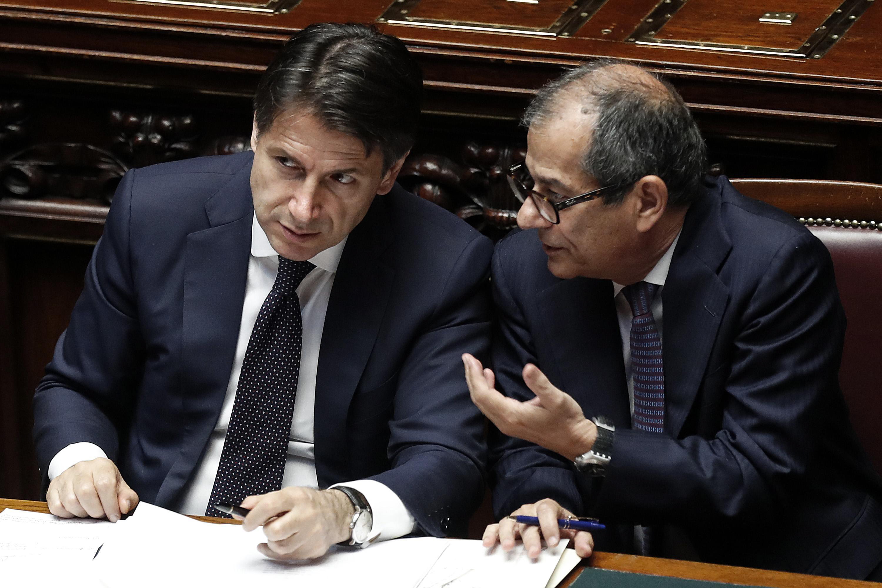 epa06788456 Italian premier Giuseppe Conte (L) and Italian Economy Minister Giovanni Tria (R) at the Lower House ahead of a confidence vote on the government's programme, in Rome, Italy, 06 June 2018. Conte is set to address the Lower House for a confidence vote on his government programme later on the same day, the second of two after winning the confidence of the Senate on 05 June night.  EPA/RICCARDO ANTIMIANI
