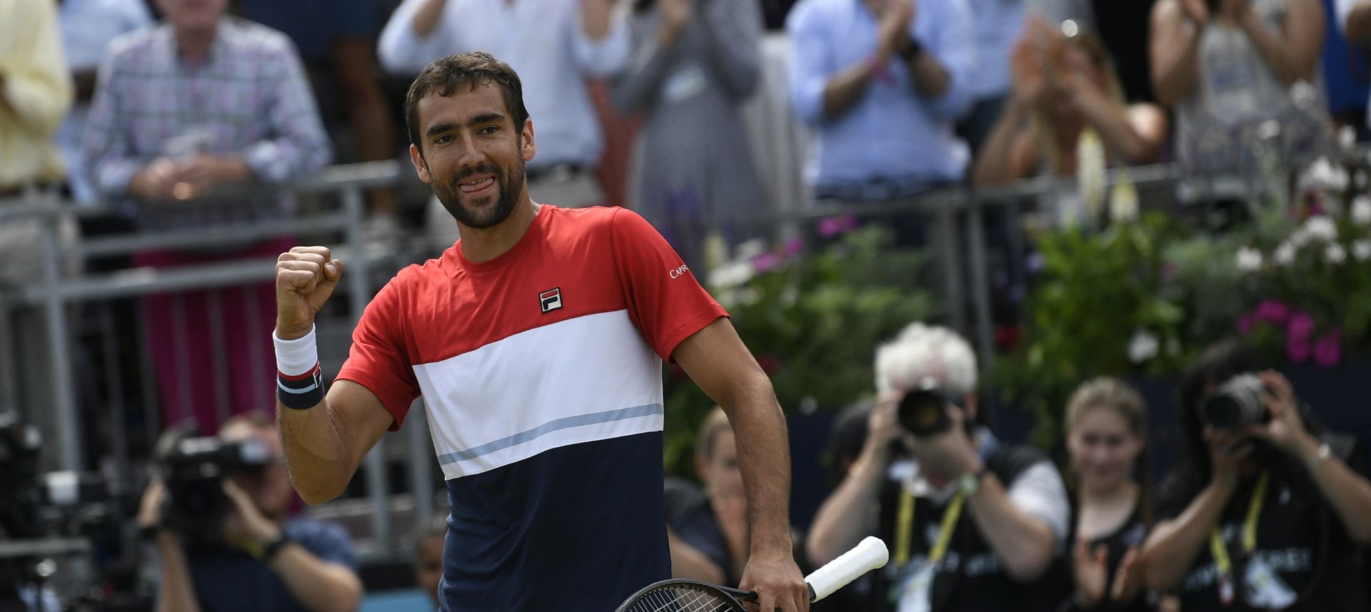 epa06833395 Marin Cilic of Croatia celebrates winning his semi-final tennis match against Australia's Nick Kyrigos at the Fever Tree Championship at Queen's Club in London, Britain, 23 June 2018.  EPA/NEIL HALL