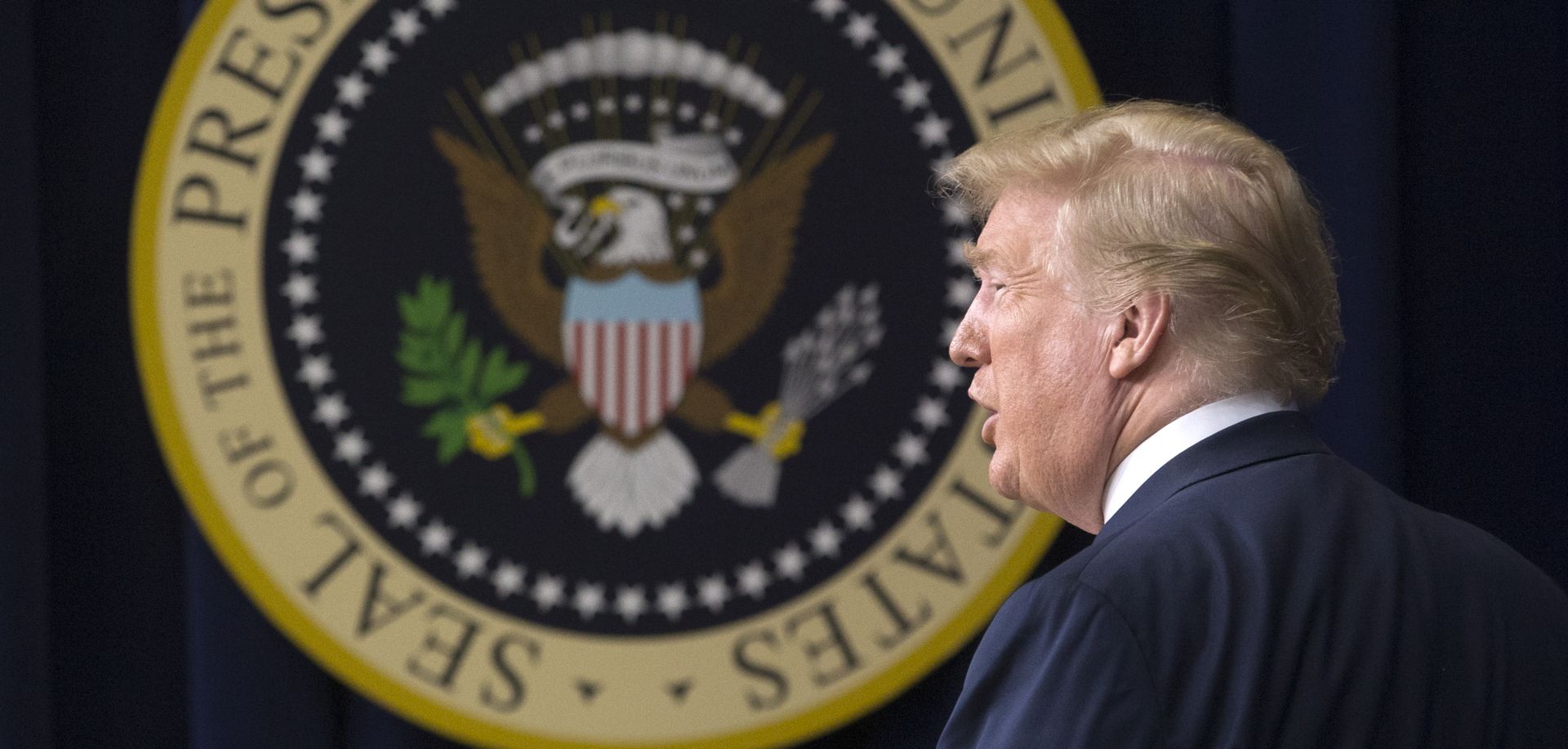 epa06845023 US President Donald J. Trump pauses in front of the Presidential seal after delivering a motivational speech to young adults, an an event being called by the White House as 'Face-to-Face With Our Future', in the Eisenhower Executive Office Building on the White House complex in Washington, DC, USA, 27 June 2018.  EPA/MICHAEL REYNOLDS