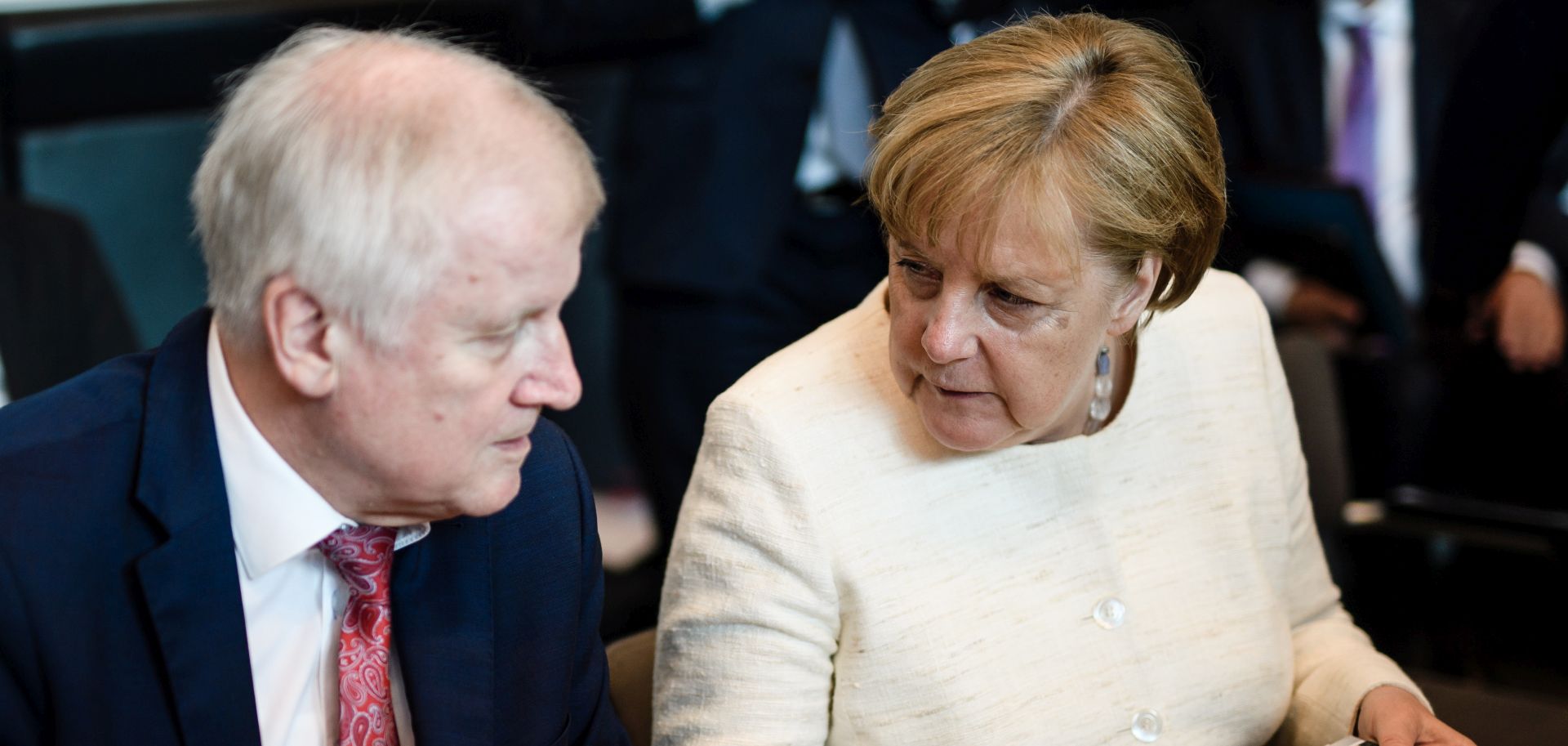 epa06802528 German Interior Minister Horst Seehofer (L) and German Chancellor Angela Merkel sit next to each other during the beginning of CDU/CSU parliamentary group meeting in Berlin, Germany, 12 June 2018. Party members of the parties Christian Democratic Union and Christian Social Union gather for their faction meeting on a regular basis.  EPA/CLEMENS BILAN