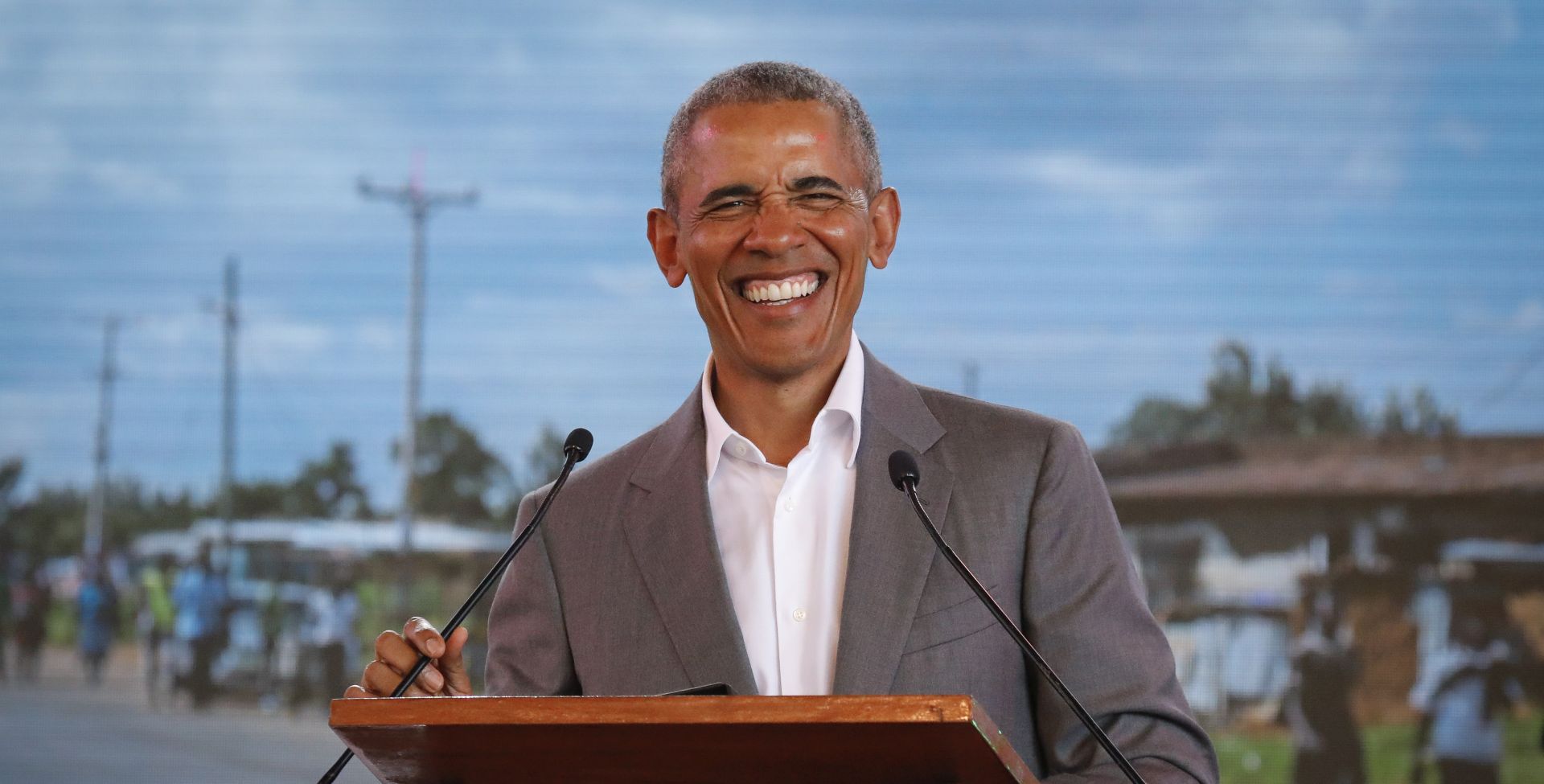 epa06892891 Former US president Barack Obama smiles as he delivers a speech during an opening ceremony of the Sauti Kuu Sports, Vocational and Training Centre in his ancestral home Kogelo, some 400km west of the capital Nairobi, Kenya, 16 July 2018. Barack Obama visited his ancestral home in western Kenya to attend the opening ceremony of the centre founded by his half-sister Auma Obama, after having met with Kenyan President Uhuru Kenyatta and opposition politician Raila Odinga in Nairobi the previous day. After Kenya, Obama is scheduled to travel to South Africa where he will deliver the annual Nelson Mandela lecture in Johannesuburg.  EPA/DAI KUROKAWA