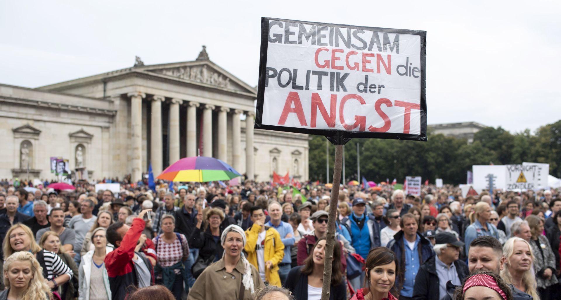 epa06904475 A protester holds a placard reading: 'Together against a policy of fear' during a demonstration against right-wing politics and what they say was anti-democracy tendencies within the Bavaria-ruling Christian Social Union (CSU) party, in Munich, Bavaria, Germany, 22 July 2018. More than 130 organizations had called for the demonstration in the Bavarian capital's centre under the keyword and hashtag #ausgehetzt, aimed at sending a 'signal against the massive shift to the right in society, the surveillance state, the restriction of freedom and attacks on human rights'. According to police up to 15,000 participants joined the protest rally, organizers said there were some 25,000 demonstrators.  EPA/LUKAS BARTH-TUTTAS