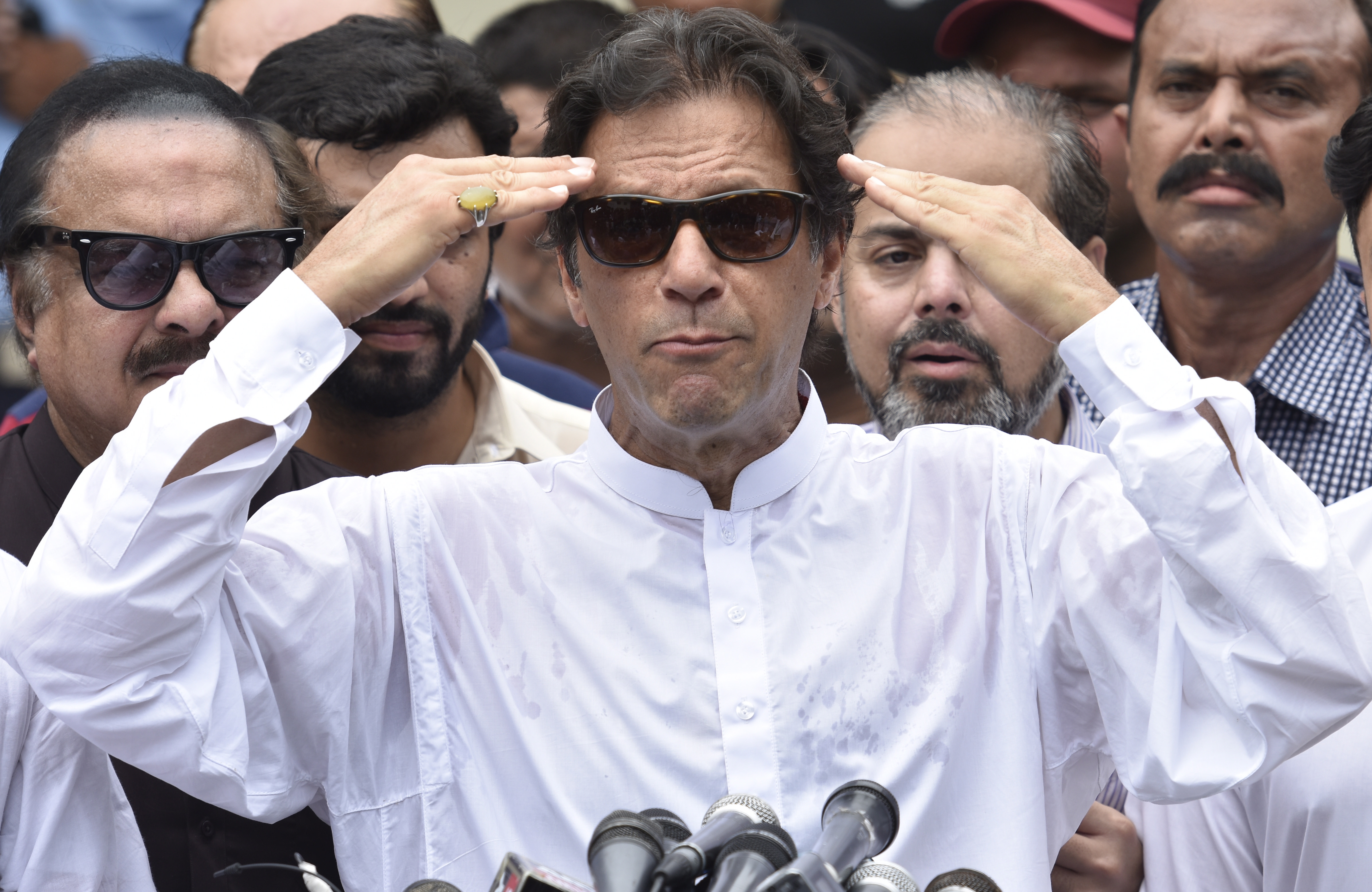 epa06909354 Imran Khan, head of Pakistan Tehrik-e-Insaf (PTI) speaks to journalists after casting his ballot at a polling station during general elections in Islamabad, Pakistan, 25 July 2018. Polling stations in Pakistan opened on 25 July, for the general elections convened for around 105 constituents. Voters will have to choose from 11,000 candidates to elect 272 members of the Parliament for the next term. These elections are the second in Pakistan's history in which a government was able to complete its term to make way for another government after being ruled by military dictators for half of the 71 years of its existence since its founding in 1947.  EPA/T. MUGHAL
