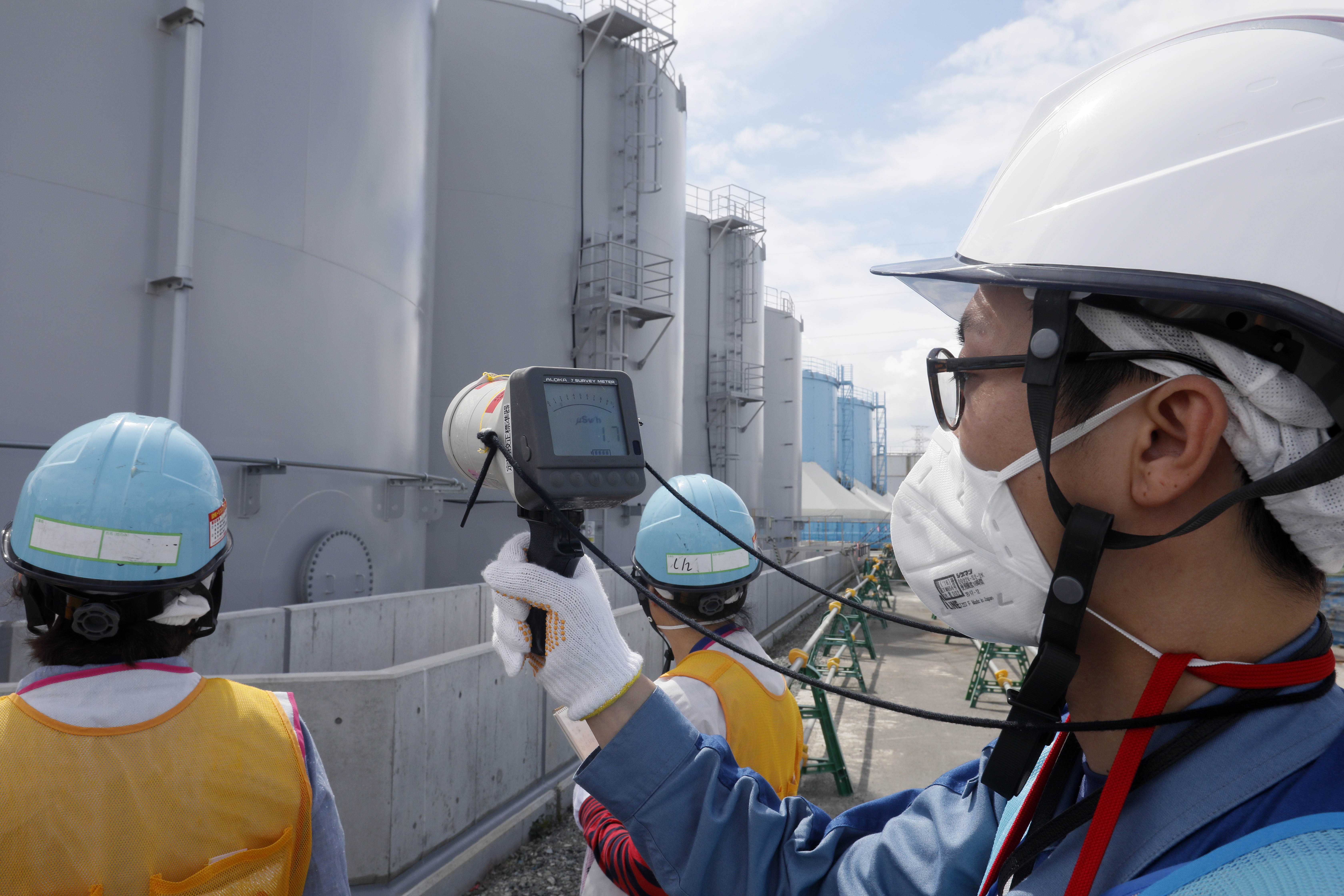 epa06918772 Staff of Tokyo Electric Power Company measure radiation level around storage tanks of radiation contaminated water at the tsunami-crippled Tokyo Electric Power Company's Fukushima Daichi Nuclear Power Plant under decommissioning works in Okuma, Fukushima Prefecture Tokyo, northern Japan, 27 July 2018, (issued 30 July 2018). The nuclear power plant  was devastated on 11 March 2011 by tsunami following the magnitude 9.0 earthquake. Tanks are build in Okuma and unit 5 and 6 are in Futaba, Fukushima Prefecture.  EPA/KIMIMASA MAYAMA / POOL