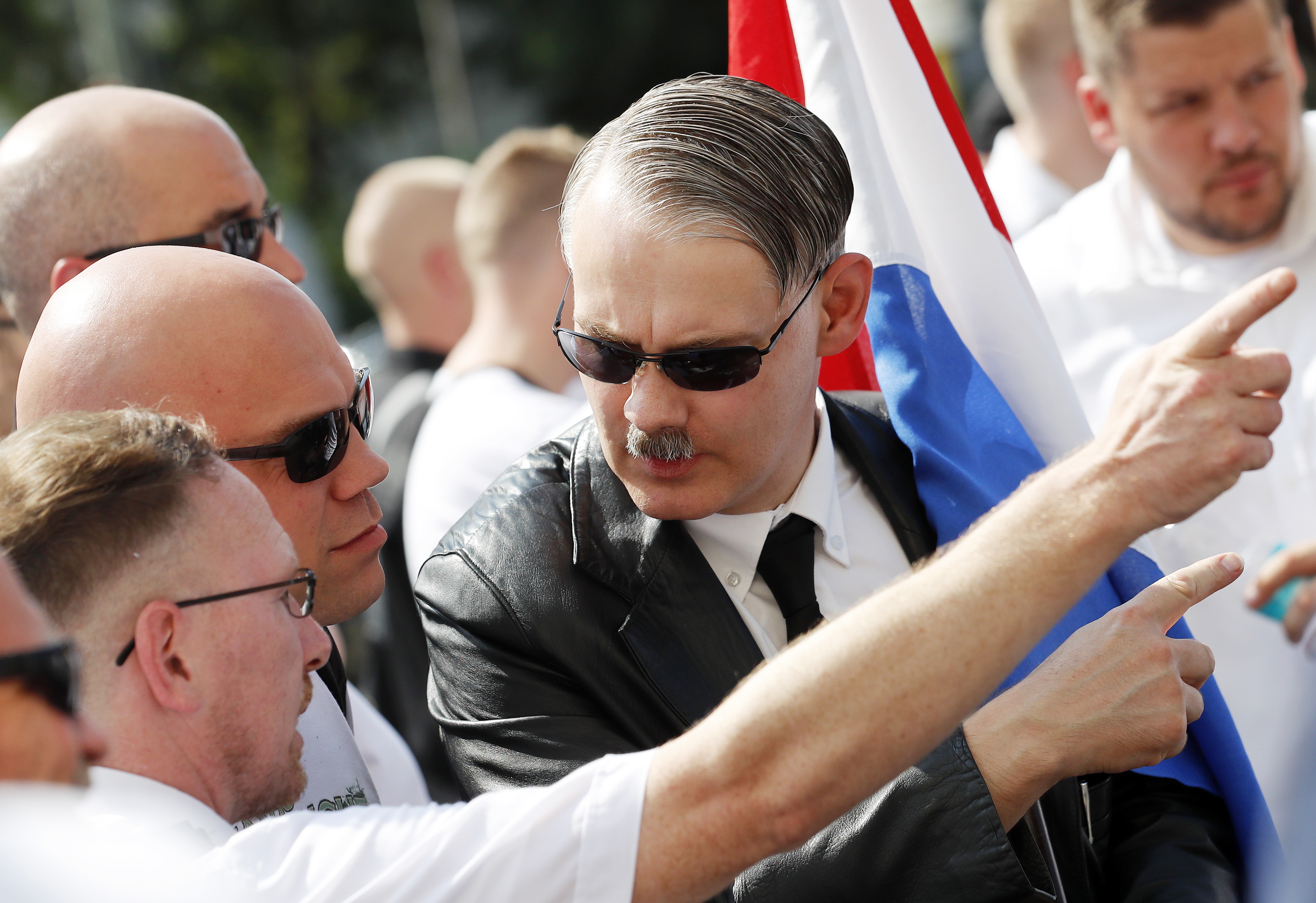 epa06956108 Far-right supporters wait for the beginning of a demonstration commemorating the death anniversary Rudolf Hess in Berlin, Germany, 18 August 2018. Hess died on 17 August 1987 after committing suicide in the Spandau Prison, where he served his life sentence. Hess was one of the most prominent Nazi leaders and appointed Deputy Fuehrer by German dictator Adolf Hitler in 1933.  EPA/FELIPE TRUEBA