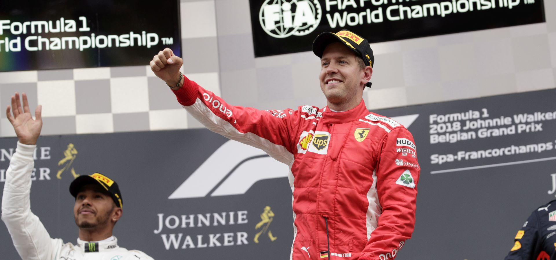 epa06974446 German Formula One driver Sebastian Vettel of Scuderia Ferrari (R) and British Formula One driver Lewis Hamilton of Mercedes AMG GP (L) celebrate on the podium after the 2018 Formula One Grand Prix of Belgium, at the Spa-Francorchamps race track near Francorchamps, Belgium, 26 August 2018.  EPA/VALDRIN XHEMAJ
