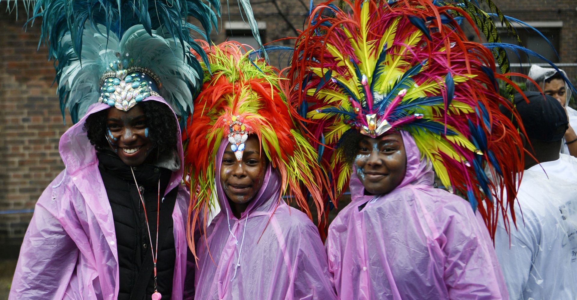 epa06974352 Performers wear raincoats as they take part in the Notting Hill Carnival Family Day in London, Britain, 26 August 2018. The street festival celebrates its 52nd anniversary and more than a million people are expected to attend the two-day celebration of Caribbean heritage on 26 and 27 August.  EPA/NEIL HALL
