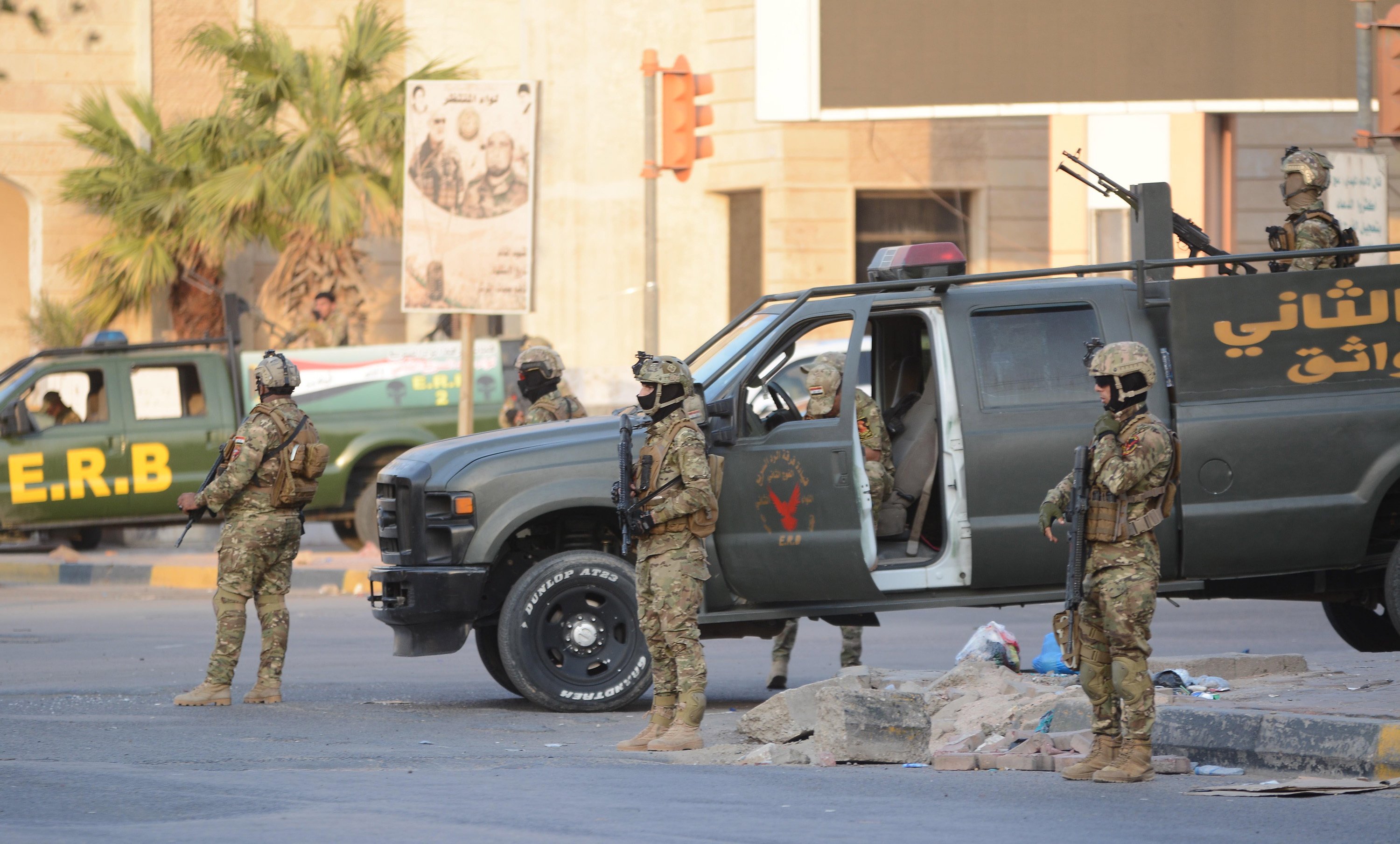 epa07005935 Members of the Iraqi Emergency Response Brigade (ERB) forces stand guard at a street in central Basra city, southern Iraq on 08 September 2018. The Iraqi government has deployed additional military forces to impose the security in Basra city a day after the Iraqi protesters stormed and set on fire the Iranian consulate and the office of Shiite Popular Mobilization Forces in the city . At least nine protesters were killed in clashes with security forces during the wave of protests that swept the city since June 2018 against corruption and poor government services.  EPA/MURTAJA LATEEF