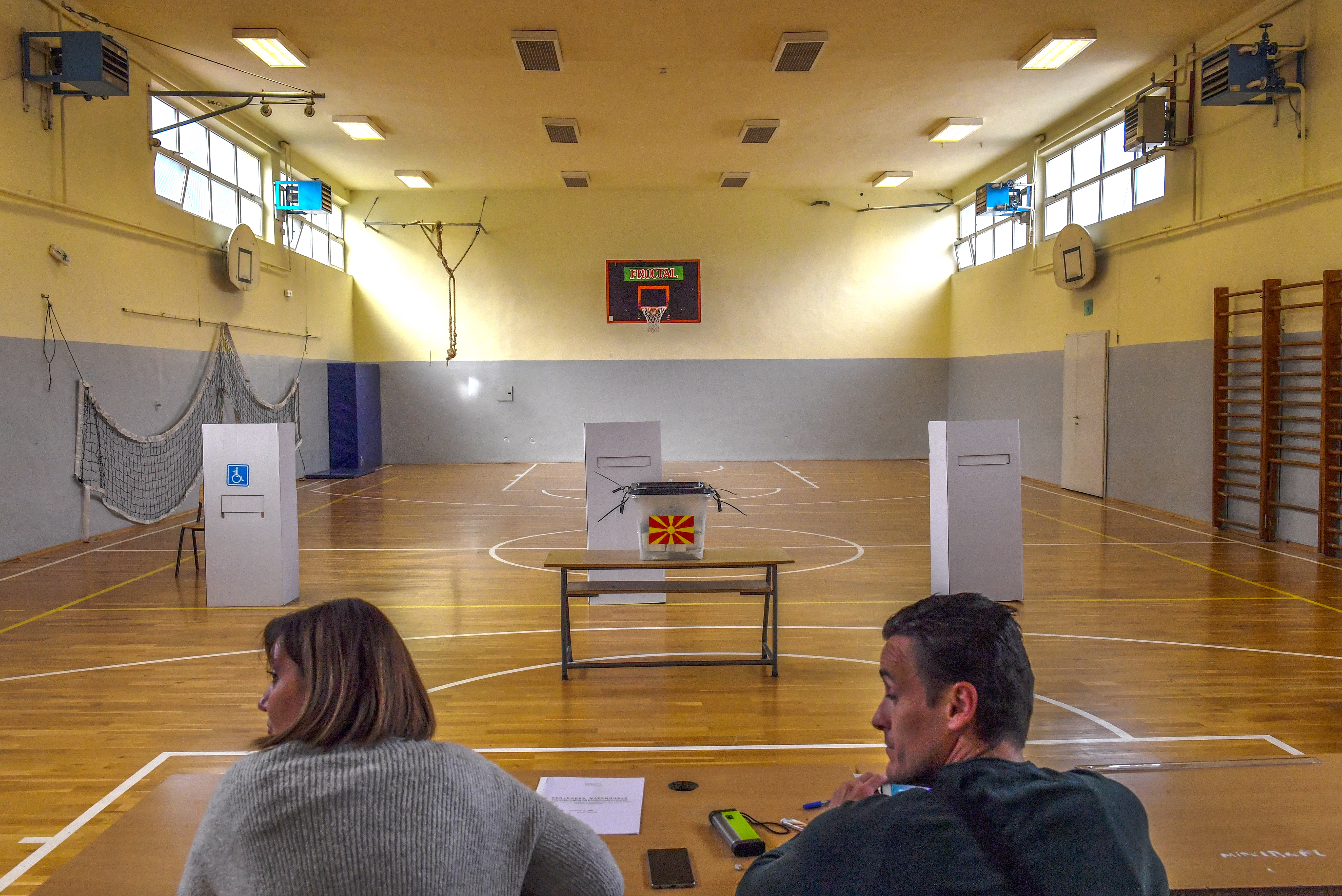 epa07059107 Members of the State Electoral Committee at the empty polling station in Skopje, The Former Yugoslav Republic of Macedonia (FYROM), 30 September 2018. Almost two million citizens will vote in a national referendum on 30 September, on whether to change the country's name to 'North Macedonia' to endorse a name deal between FYR of Macedonia and Greece and to qualify for NATO membership.  EPA/GEORGI LICOVSKI