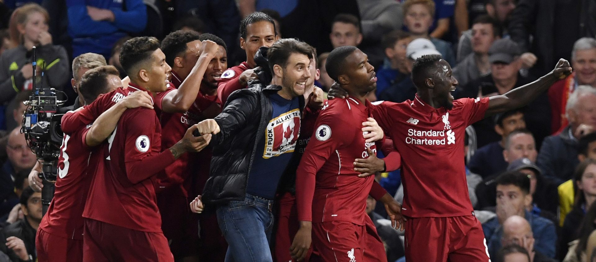 epa07057342 Liverpool's Daniel Sturridge (2-R) celebrates with teammates and a pitch invader after scoring the 1-1 goal during the English Premier League soccer match between Chelsea FC and Liverpool FC at Stamford Bridge, London, Britain, 29 September 2018.  EPA/WILL OLIVER EDITORIAL USE ONLY. No use with unauthorized audio, video, data, fixture lists, club/league logos or 'live' services. Online in-match use limited to 120 images, no video emulation. No use in betting, games or single club/league/player publications.