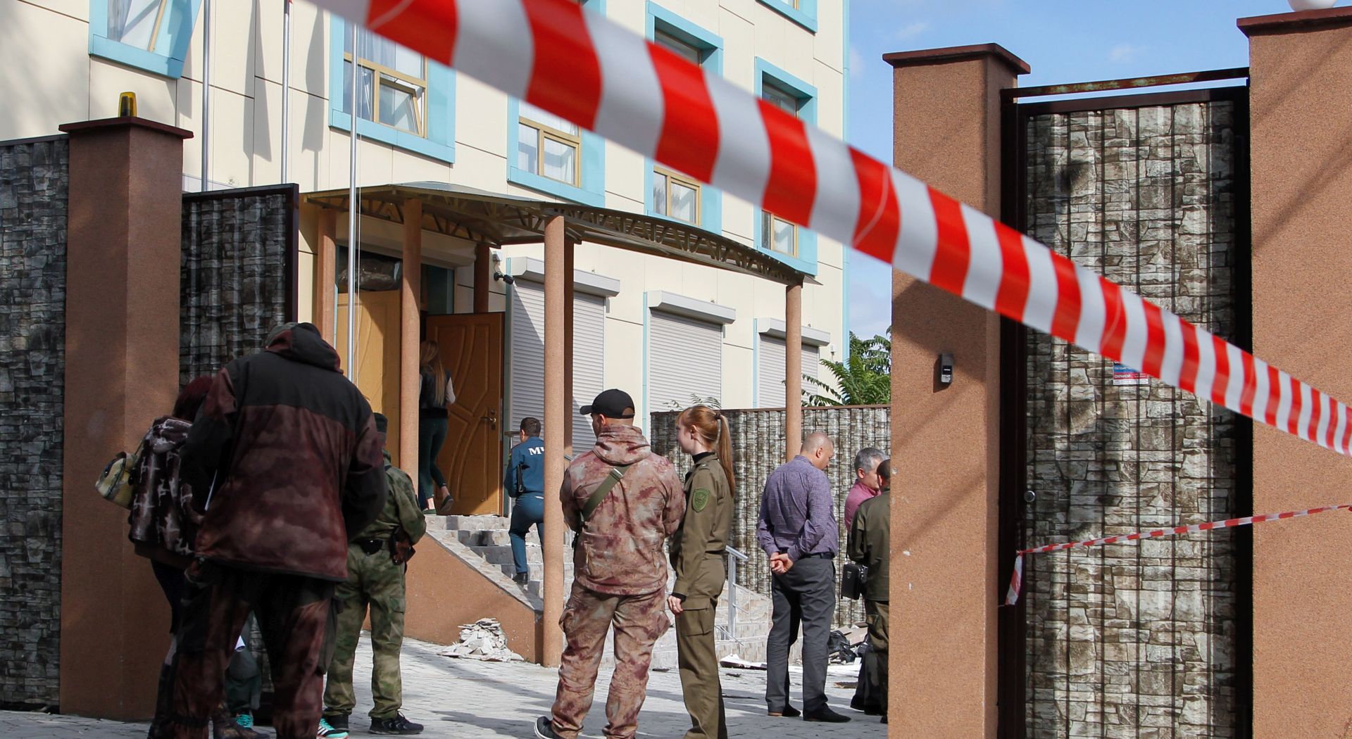 epa07057168 Pro-Russian militants and local policemen stand near the site of explosion in downtown Donetsk, Ukraine, 29 September 2018. Four people, including a candidate for the head of the self proclaimed Donetsk People's Republic (DPR) Igor Khakimzyanov, have been injured in an explosion in the pro-Russian militants controlled city of Donetsk. The explosion took place in a building where the DPR Communist Party held a meeting.  EPA/ALEXANDER ERMOCHENKO