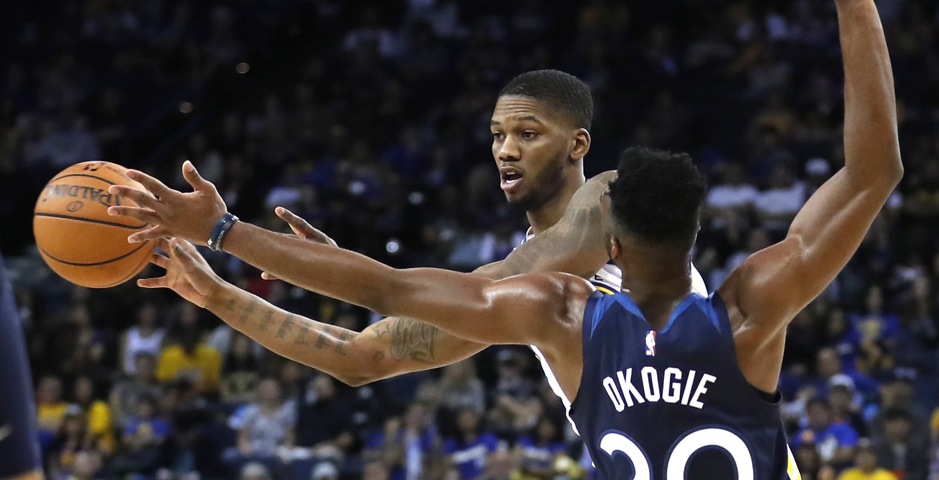 epa07058053 Golden State Warriors forward Alfonzo McKinnie (L) looks to pass as Minnesota Timberwolves guard Josh Okogie (R) defends during the second half of their NBA preseason game at Oracle Arena in Oakland, California, USA, 29 September 2018.  EPA/JOHN G. MABANGLO  SHUTTERSTOCK OUT