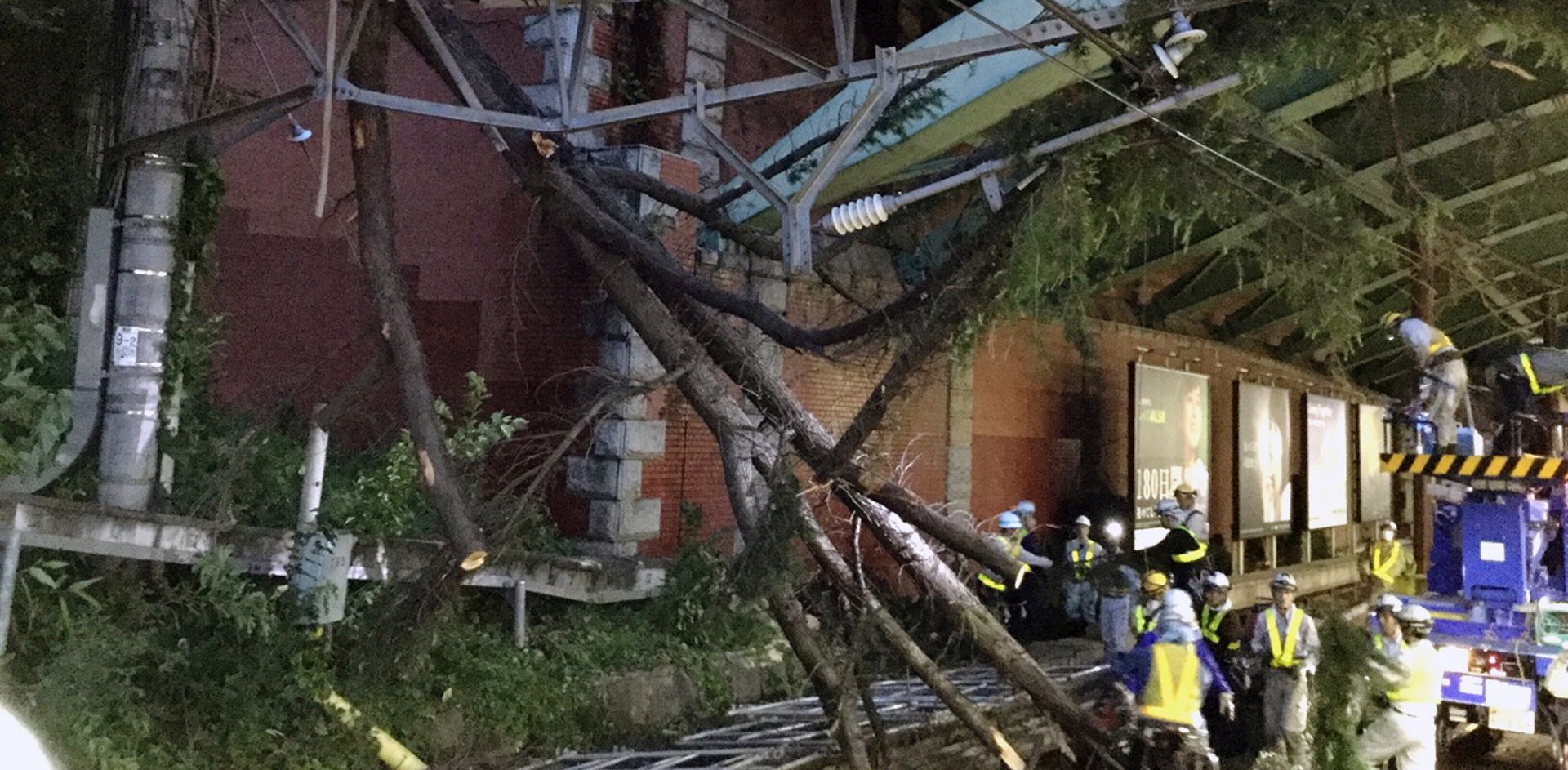 epa07060574 Staff members work on clearing railway tracks of fallen trees following typhoon Trami in Tokyo, Japan, 01 October 2018. Powerful typhoon Trami moved across Japan, hitting the entire country with strong winds. Transportation services were largely disrupted across the country, with the suspension of bullet train services and cancellation of more than 1,000 flights. According to media reports, two people were killed and more than 80 people injured.  EPA/JIJI PRESS JAPAN OUT EDITORIAL USE ONLY/  NO ARCHIVES