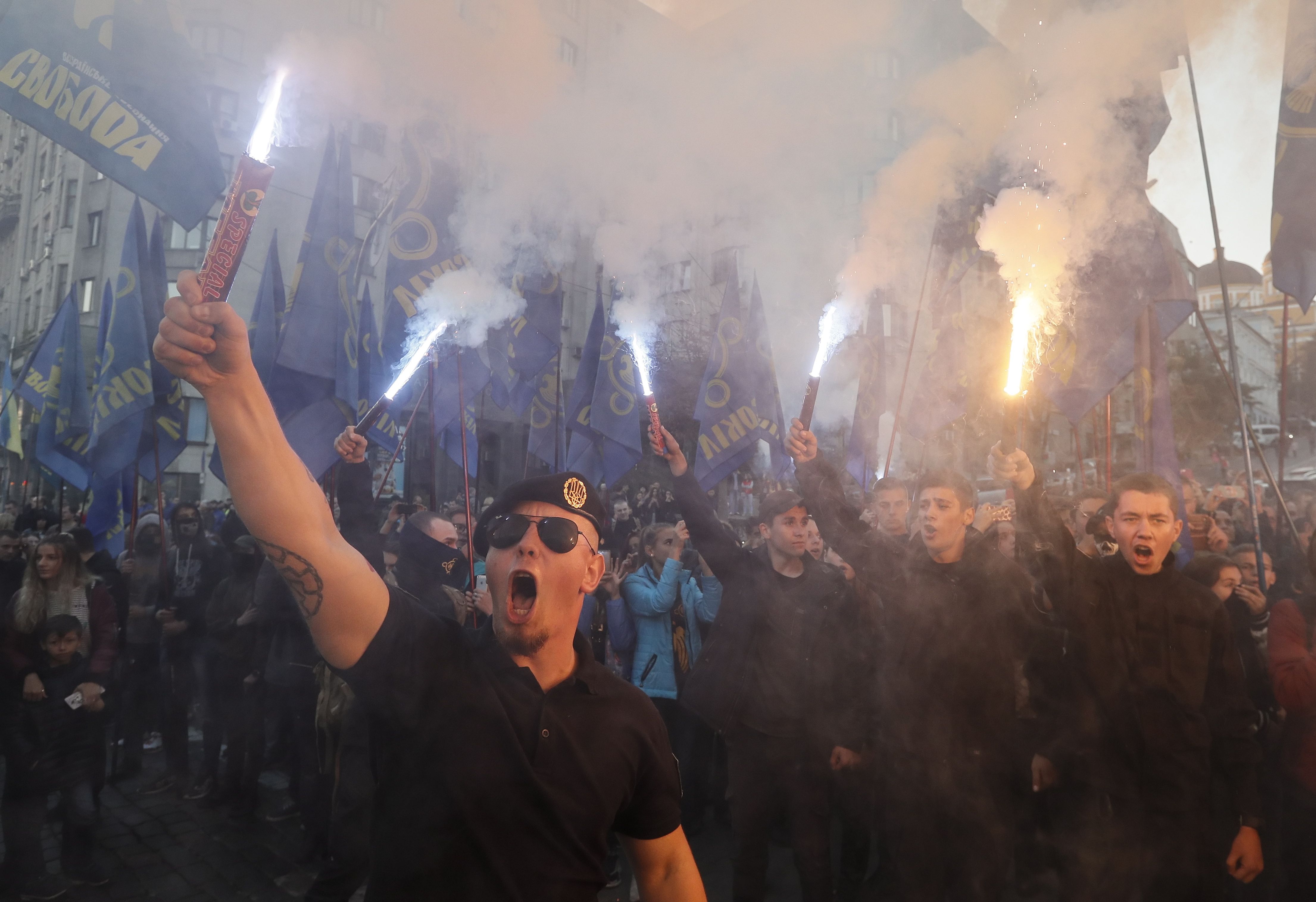 epa07092939 Activists and supporters of Ukrainian nationalist parties burn flares, torches and smoke grenades during their march to mark the 76th anniversary of the creation of the Ukrainian Insurgent Army (UPA), in downtown Kiev, Ukraine, 14 October 2018. The UPA acted mainly in the west of Ukraine until the beginning of the 1950s and had more than 40,000 soldiers in its strongest period. The UPA fought for Ukrainian independence against the Soviet Red Army and the Nazis during the Second World War.  EPA/SERGEY DOLZHENKO
