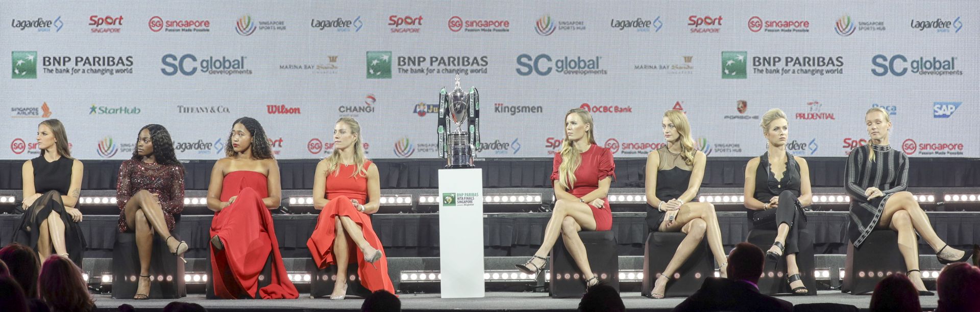 epa07104604 (L-R) Karolina Pliskova of the Czech Republic, Sloane Stephens of the USA, Naomi Osaka of Japan, Angelique Kerber of Germany, Caroline Wozniacki of Denmark, Petra Kvitova of the Czech Republic, Elina Svitolina of Ukraine, and Kiki Bertens of the Netherlands are pictured flanking the Billie Jean King Trophy during the singles draw ceremony for the BNP Paribas WTA Finals 2018 held at the Marina Bay Sands Hotel in Singapore, 19 October 2018. The BNP Paribas WTA Finals 2018 will take place from 21-28 October 2018 at the Singapore Indoor Stadium.  EPA/WALLACE WOON