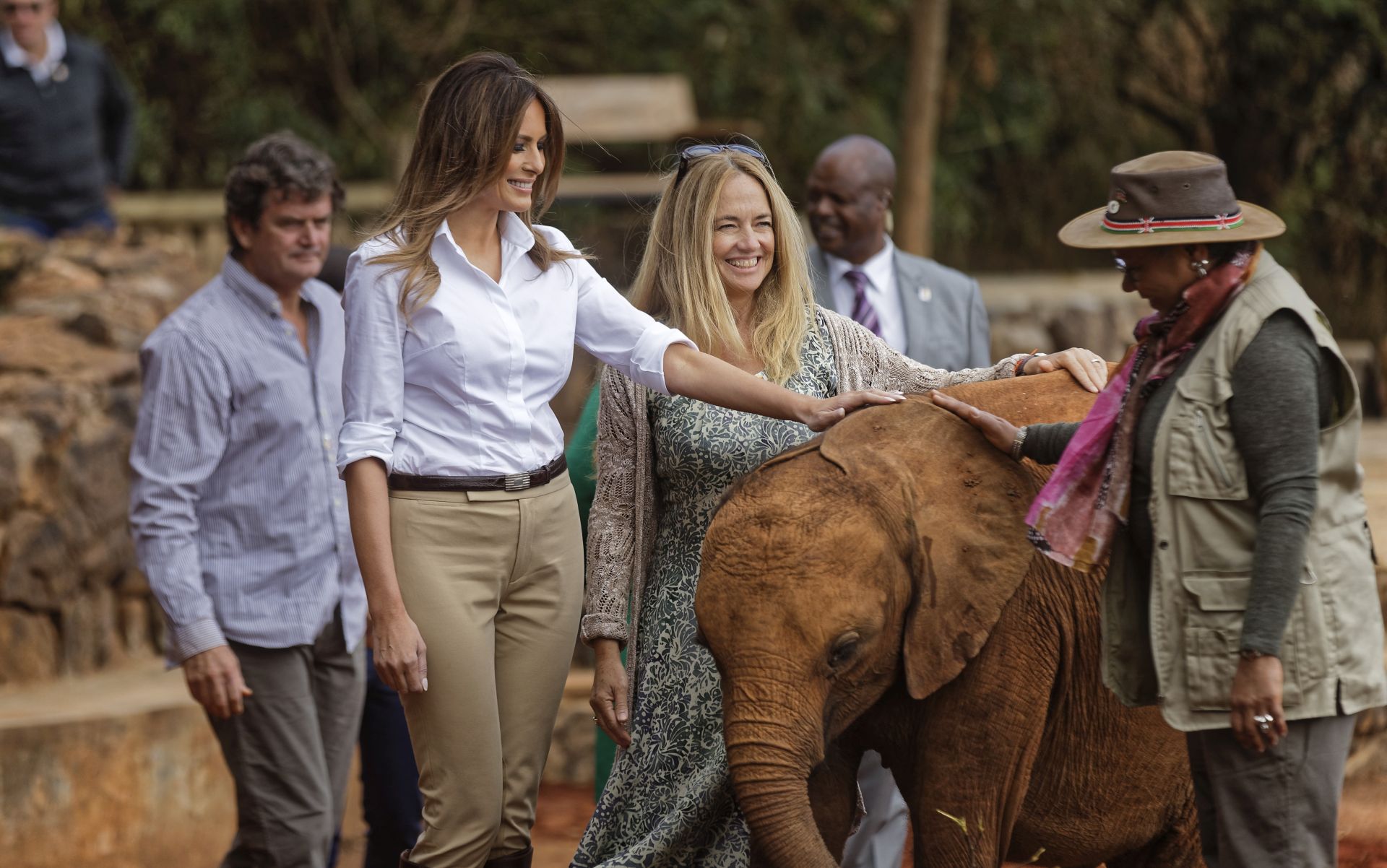 epa07070941 United States First Lady Melania Trump (L) pets a baby elephant, accompanied by CEO Angela Sheldrick (C) and Kenya's first lady Margaret Kenyatta (R) at the David Sheldrick Wildlife Trust elephant orphanage in Nairobi, Kenya, 05 September 2018. This is the first major solo international trip to Africa for the US First Lady where she is promoting child welfare and education. Melania Trump's trip to Africa will include Ghana, Malawi, Kenya and Egypt.  EPA/BEN CURTIS / POOL