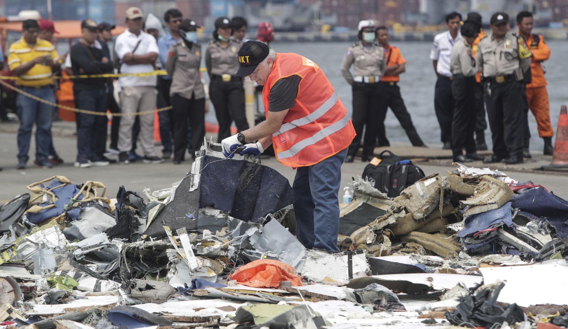 epa07134581 An US National Transportation Safety Board officer examines recovered Lion Air JT-610 debris at the collection point at Tanjung Priok Harbour, in Jakarta, Indonesia, 01 November 2018. Lion Air flight JT-610 lost contact with air traffic controllers soon after takeoff then crashed into the sea on 29 October. The flight was en route to Pangkal Pinang, and reportedly had 189 people onboard. On 01 November, search and rescue divers located one of the plane's black box flight recorders.  EPA/ADI WEDA