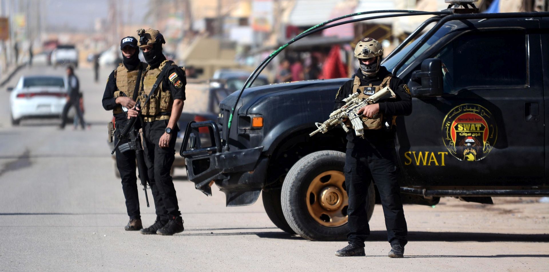epa07138532 Members of Iraqi Special Weapons and Tactics (SWAT) team stand guard at a street in the border town of al-Qaim, 500 km west of Iraq, 02 November 2018 (issued 03 November 2018).  The Iraqi security forces and Iraqi Shiite popular mobilization forces have sent reinforcements, including heavy armored vehicles, to the Iraqi borders with Syria, to secure the area after Syrian villages were recaptured by Islamic state group near the borders. The Iraqi-Syrian borders are under the control of joint troops of military and border guards, Yahya Rasul, spokesperson for Iraqi Joint Operation said.  EPA/MURTAJA LATEEF