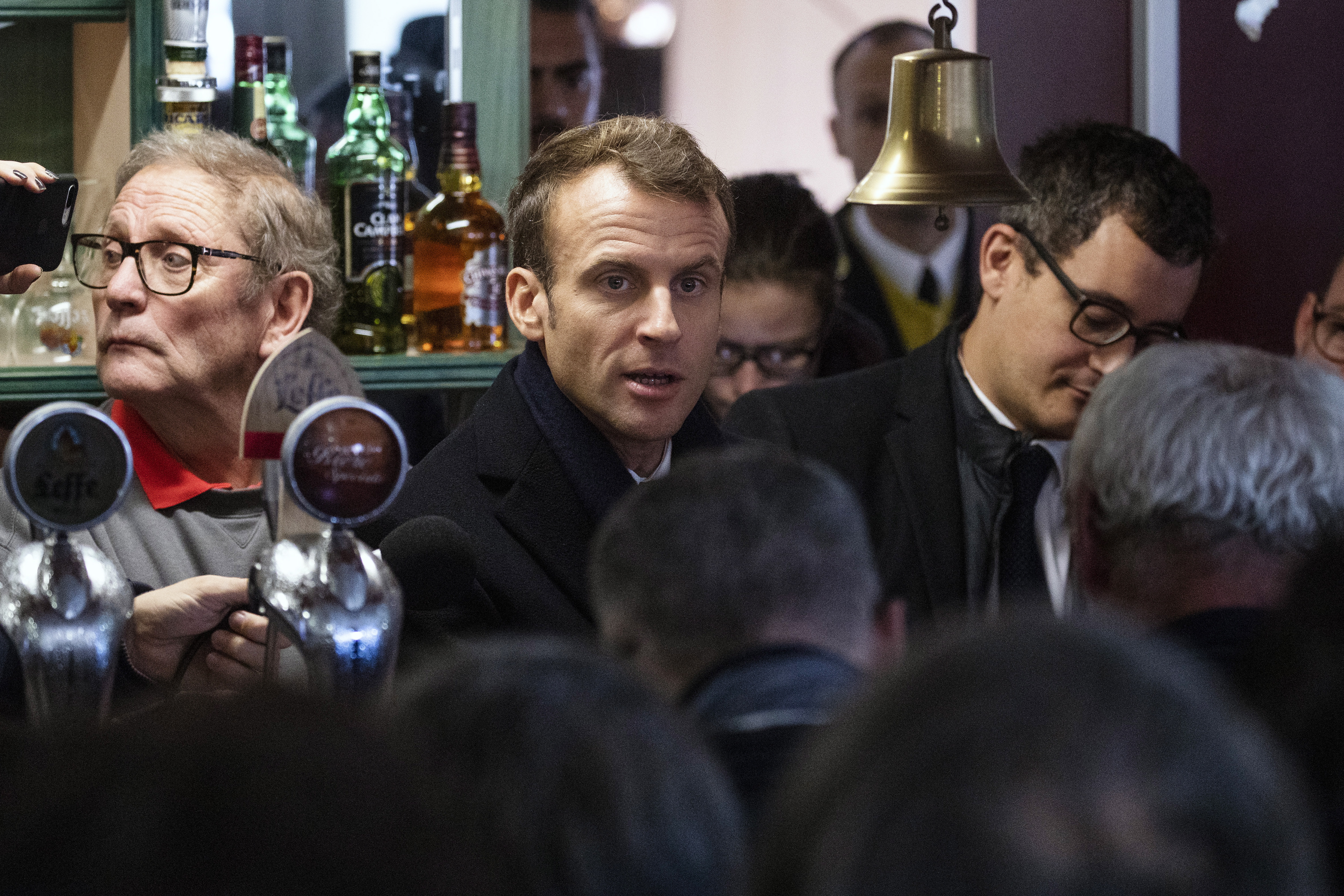 epa07153309 French President Emmanuel Macron meets with locals in a bar where he promised to return during his presidential campaign, in Lens, France, 09 November 2018. Macron is currently on a six-day tour to visit the most iconic landmarks of the First World War ahead of the commemorations of the 100th anniversary of the 11 November 1918 armistice.  EPA/ETIENNE LAURENT / POOL