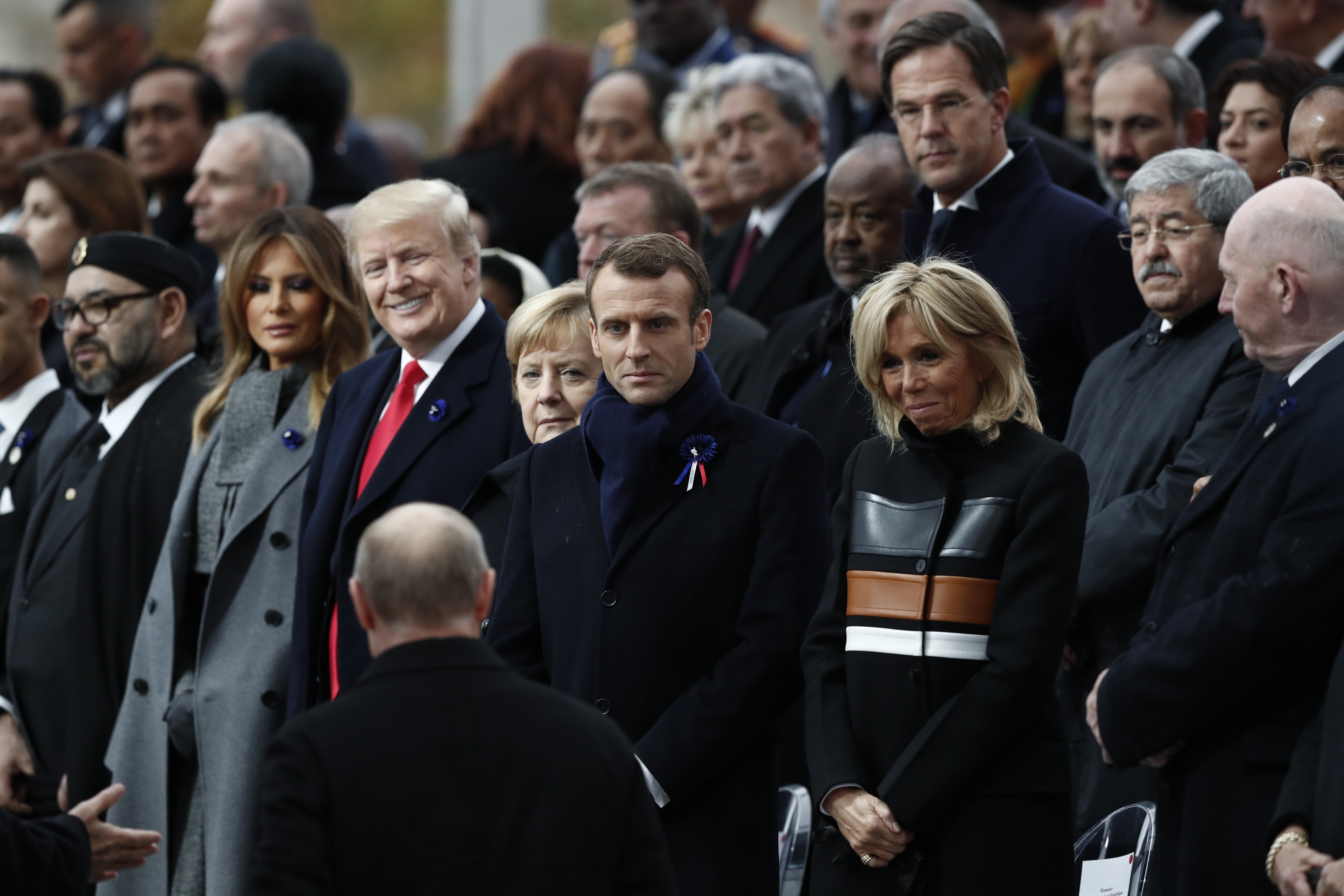 epa07157549 Russian President Vladimir Putin (front) arrives to take his place with French President Emmanuel Macron (C-R), Brigitte Macron (3-R), German Chancellor Angela Merkel (C-L), US President Donald J. Trump (3-L) and first lady Melania Trump (2-L) to attend the international ceremony for the Centenary of the WWI Armistice of 11 November 1918 at the Arc de Triomphe, in Paris, France, 11 November 2018. Heads of State and Government commemorate their fallen soldiers in France.  EPA/BENOIT TESSIER / POOL MAXPPP OUT