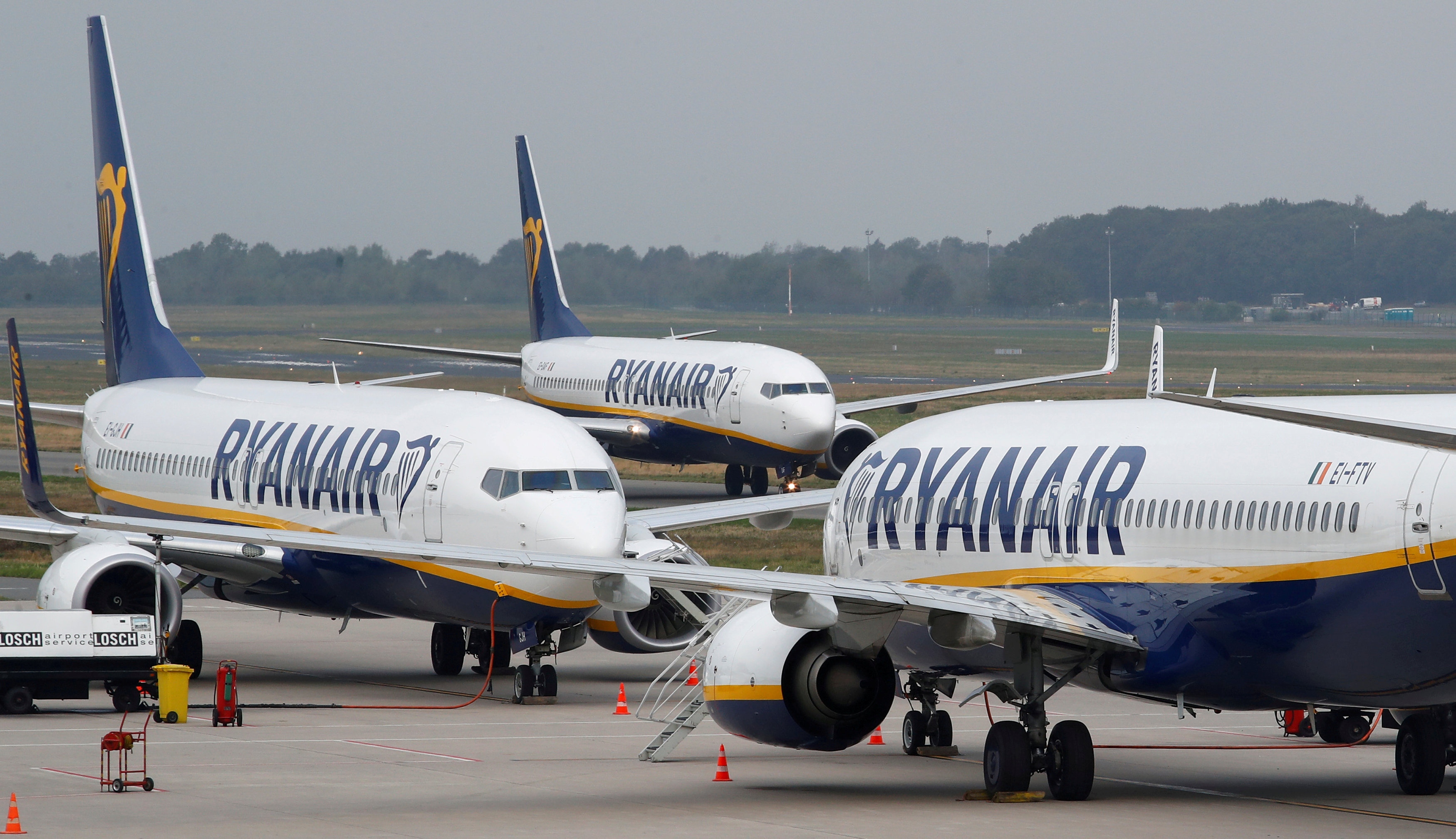 FILE PHOTO: Ryanair airplane taxis past two parked aircraft at Weeze Airport FILE PHOTO: A Ryanair airplane taxis past two parked aircraft at Weeze Airport, near the German-Dutch border, during a strike of Ryanair airline crews in Weeze, Germany, September 12, 2018. REUTERS/Wolfgang Rattay/File Photo Wolfgang Rattay