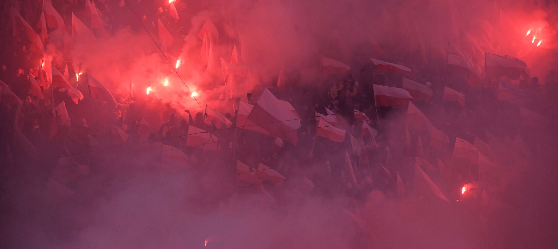 epa07158776 Demonstrators light flares as they gather in the city center to take part in the National White and Red March 'For You Poland' to mark Polish Independence Day in Warsaw, Poland, 11 November 2018. Poland is celebrating the centenary of regaining of Independence on 11 November 2018.  EPA/RADEK PIETRUSZKA POLAND OUT