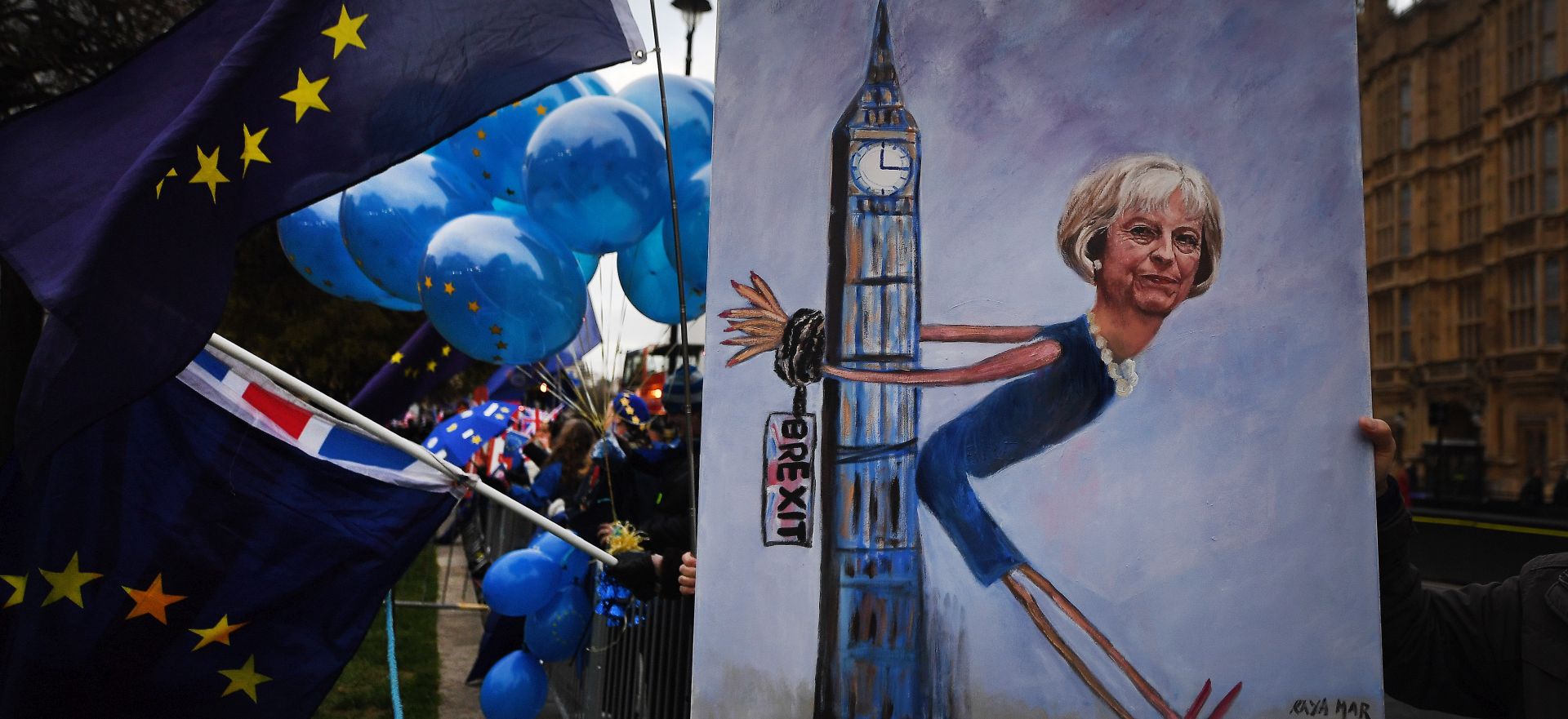 epa07221815 Political artist Kaya Mar holds his painting of British Prime Minister Theresa May chained to parliament during a demonstration outside the British Houses Parliament calling for a People's Vote in central London, Britain, 10 December 2018. Media reports on 10 December 2018 state that British Prime Minister, Theresa May is to make a statement to British Members of Parliament later in the day amid reports the the Meaningful Vote due to take place on 11 December 2018 on her Brexit deal is being delayed.  EPA/ANDY RAIN