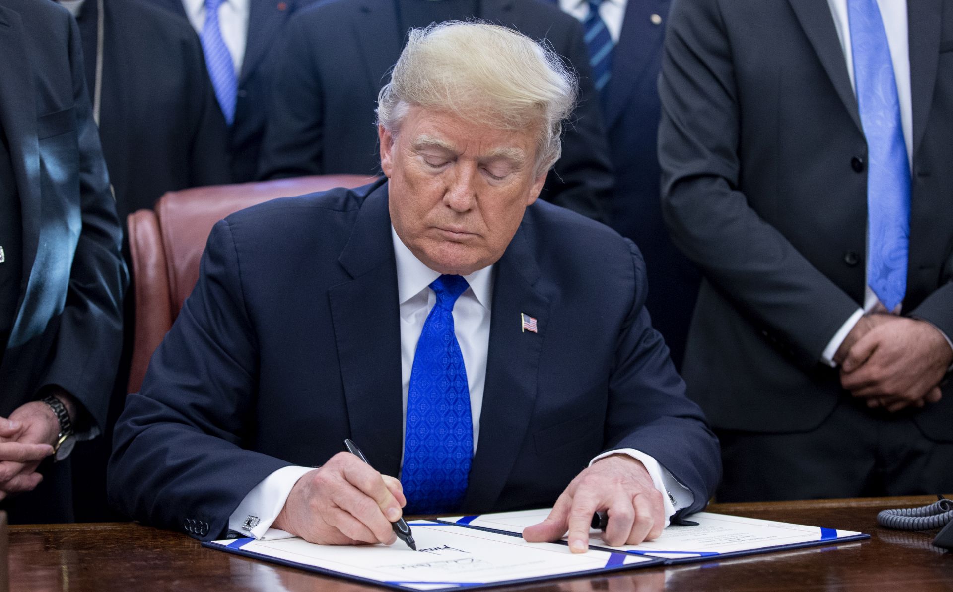 epa07224609 US President Donald J. Trump signs H.R. 390, the 'Iraq and Syria Genocide Relief and Accountability Act of 2018', in the Oval Office of the White House in Washington, DC, USA, 11 December 2018. The law will provide emergency humanitarian and recovery assistance to victims of crimes against humanity, war crimes and genocide in Iraq and Syria. The legislation also directs the US State Department to preserve evidence of genocide in those regions.  EPA/MICHAEL REYNOLDS