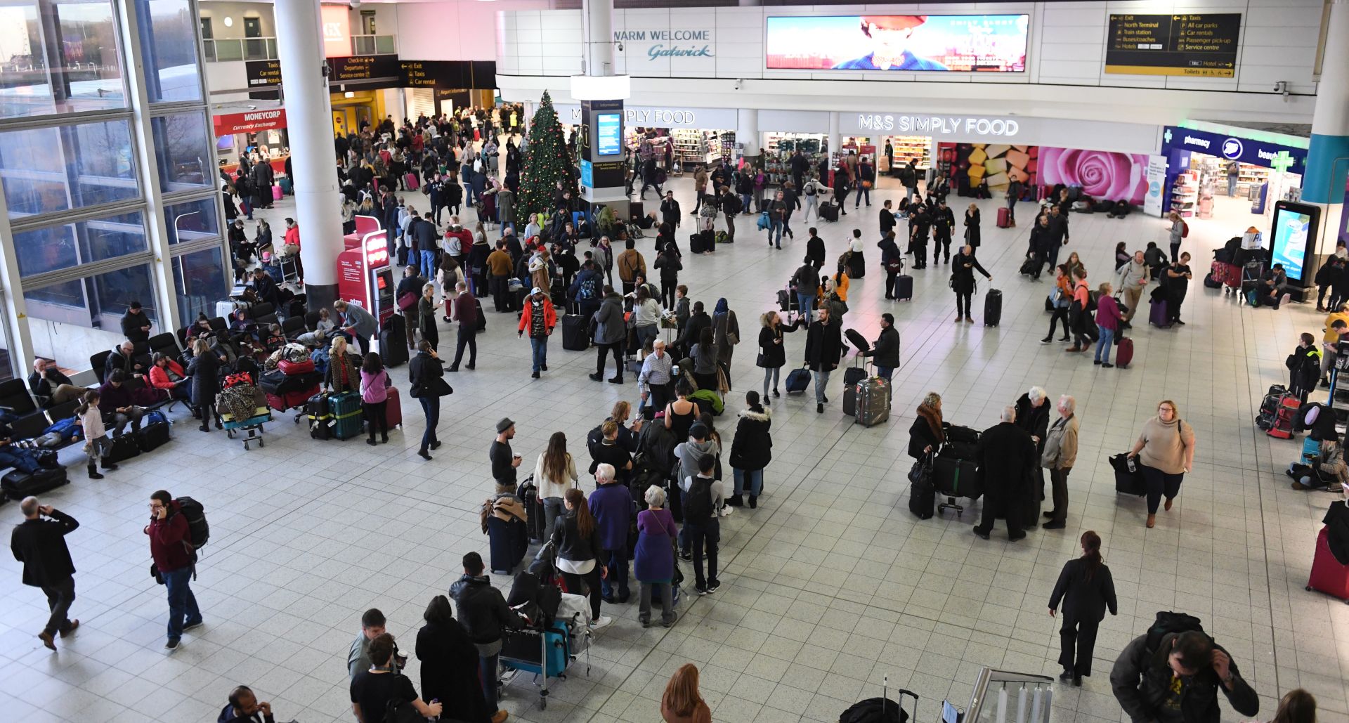 epa07241488 Passengers wait within Gatwick airport in south London, Britain, 20 December 2018. According to media reports, the runway for Gatwick Airport was shut down by authorities after sightings of drones flying near the airport. The presence of the drones appears to be an intentional effort to disrupt air traffic at the airport, and caused the suspension of all flights in and out of the airfield.  EPA/FACUNDO ARRIZABALAGA