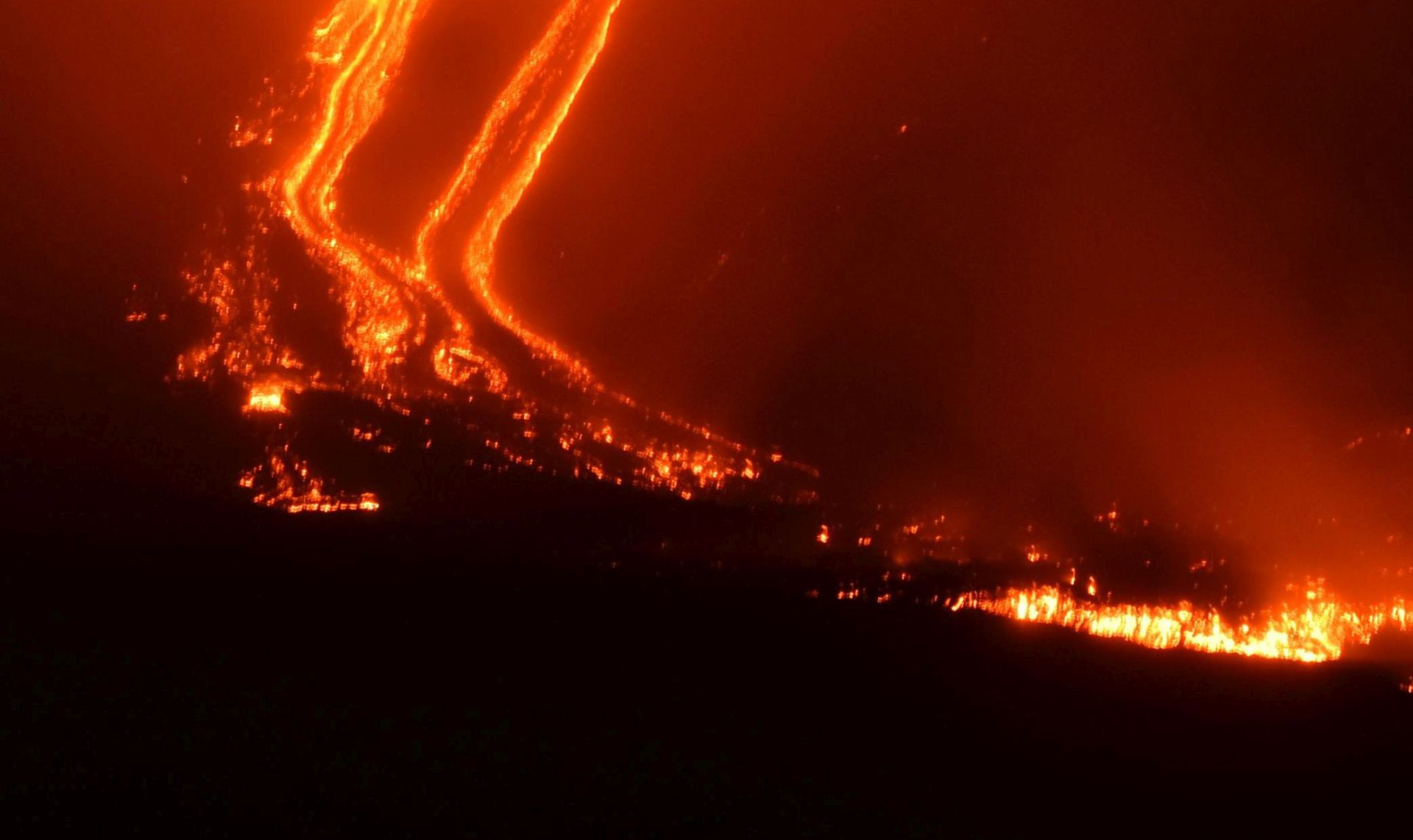 epa07248154 A view of lava flowing downhill after an eruption of the the Etna volcano, near Catania, Sicily island, southern Italy, 24 December 2018 (issued 25 December 2018). The intense seismic activities of Mount Etna continue with - among dozens of earthquakes that were detected at 08:26 pm on 24 December - the National Institute of Geophysics and Volcanology (INGV) having registered a magnitude-4 strong quake with its hypocenter at a depth of only two kilometers and the epicenter some seven kilometers northeast of Ragalna, in the province of Catania.  EPA/ORIETTA SCARDINO
