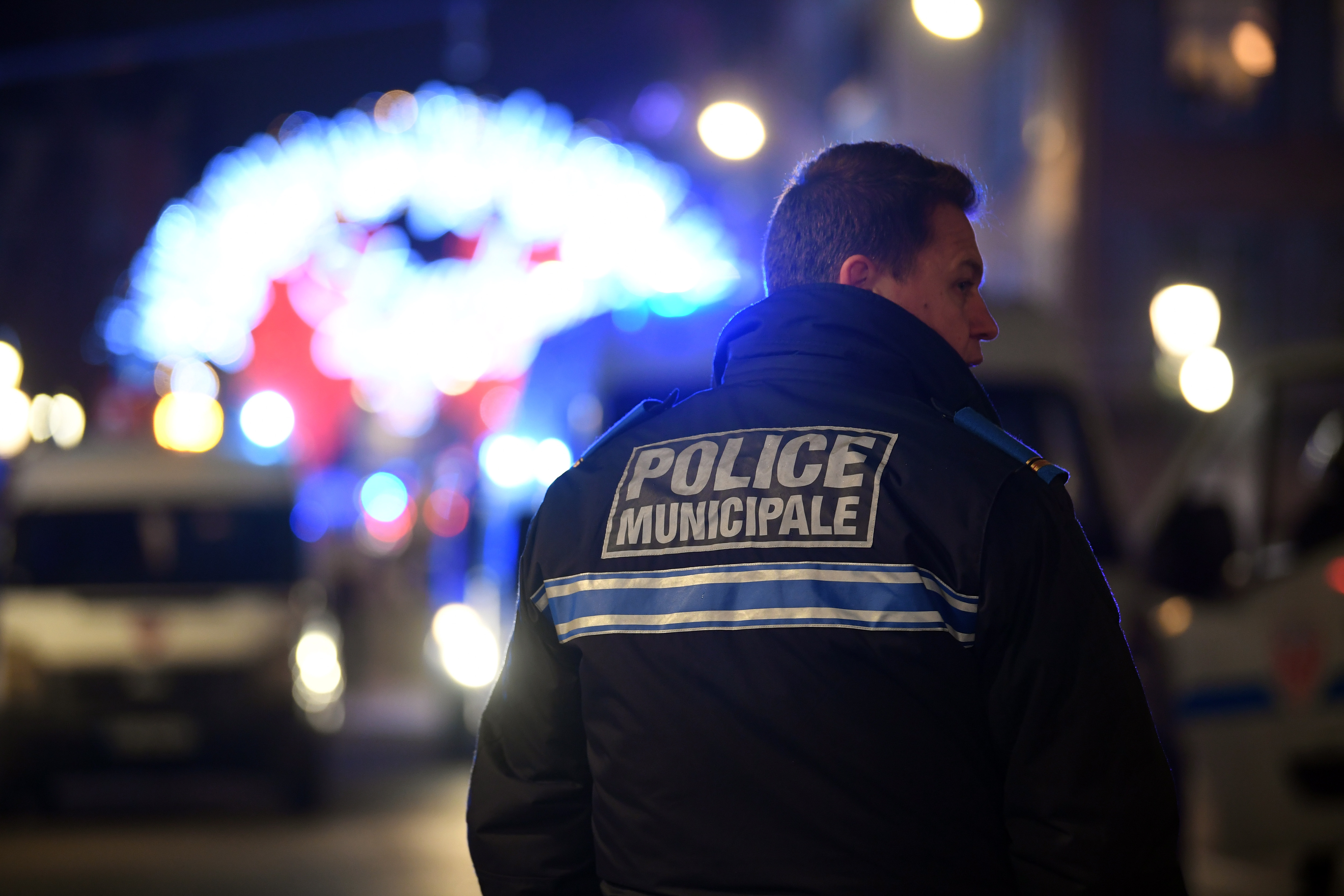 epa07224640 A French police officer stands near a shooting site at the Christmas Market in Strasbourg, Alsace, France, 11 December 2018. According to latest report, two people are dead and 11 people are injured. The gunman is reported to be at large and the motive for the attack is still unclear.  EPA/JEAN-MARC LOOS FRANCE OUT / SHUTTERSTOCK OUT / NO MAGS SALES