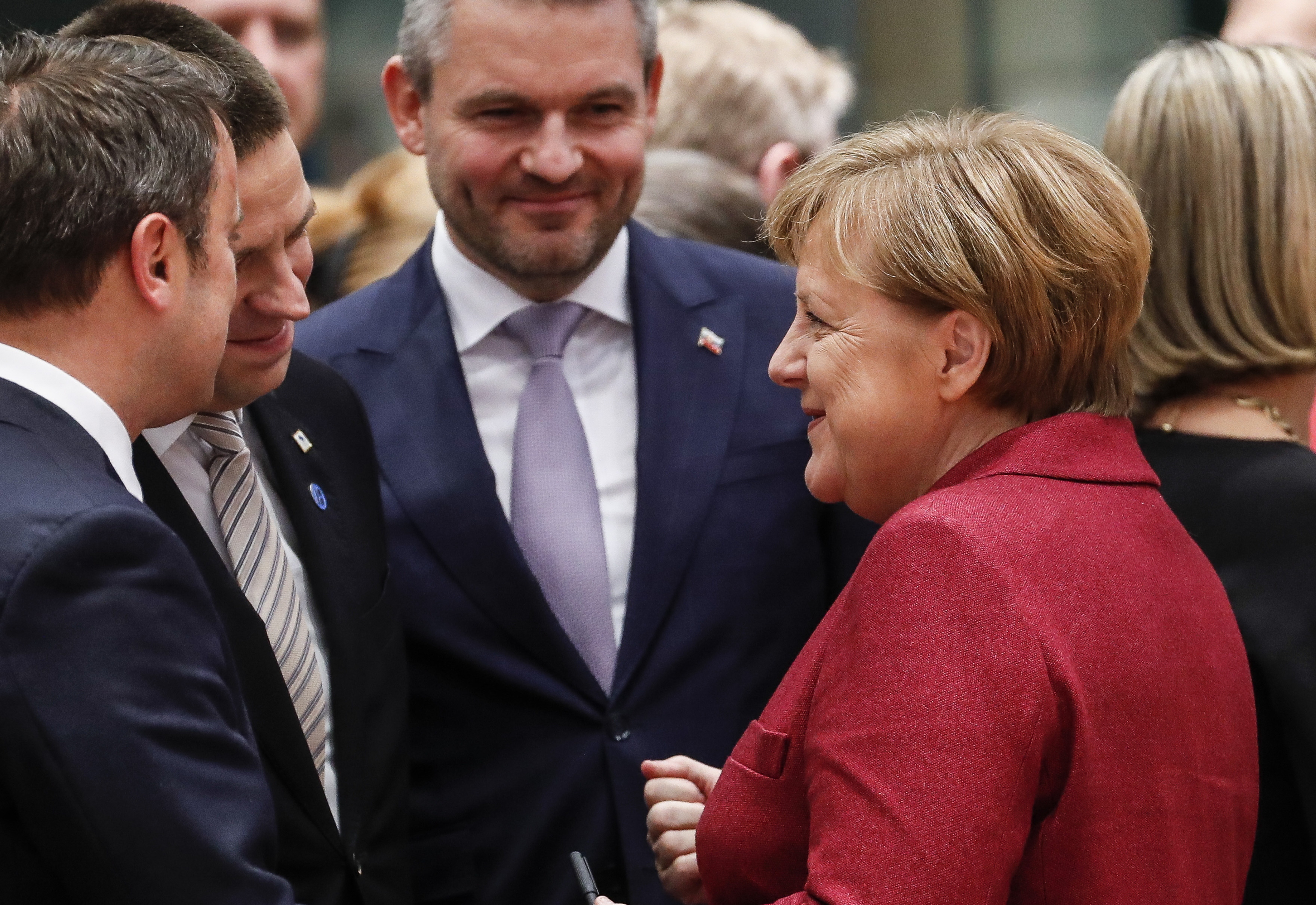 epa07228512 (L-R) Luxembourg's Prime Minister Xavier Bettel, Estonia's Prime Minister Juri Ratas, Slovakia's Prime Minister Peter Pellegrini and  German Federal Chancellor Angela Merkel chatat the start of the European Council in Brussels, Belgium, 13 December 2018. During their two days summit, European leaders will focus on  the 'Brexit' and on the EU's budget for 2021until 2027. The Summit will resume on 14 December with the EU28 adoption of the conclusions on the Single Market, climate change, migration, disinformation, the fight against racism and xenophobia, and citizens' consultations.  EPA/OLIVIER HOSLET