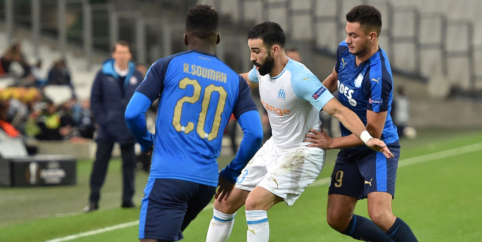 epa07229524 Adil Rami (C) of Olympique Marseille and David Faupala (R) of Apollon Limassol in action during UEFA Europa League group H soccer match between Olympique Marseille and Apollon Limassol at the Velodrome Stadium in Marseille, southern France, 28 October 2018.  EPA/ALEXANDRE DIMOU