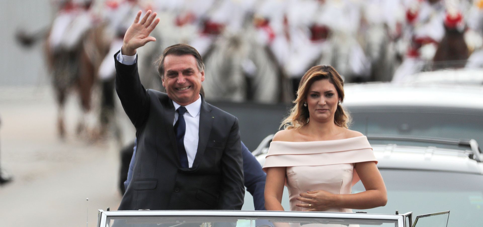 epa07257313 Brazilian President-elect Jair Bolsonaro (L) and wife Michele (R) head to the Planalto Palace on a Rolls Royce, for a ceremony in which Bolsonaro will receive the presidential band from his predecessor, Michel Temer, in Brasilia, Brazil, 01 January 2019 A far-right president leads the biggest Latin America democracy for first time since the end of military rule (1964-1985). Bolsonaro defeated candidate Fernando Haddad in the runoff, held last October, receiving 55 percent of the vote.  EPA/ANTONIO LACERDA