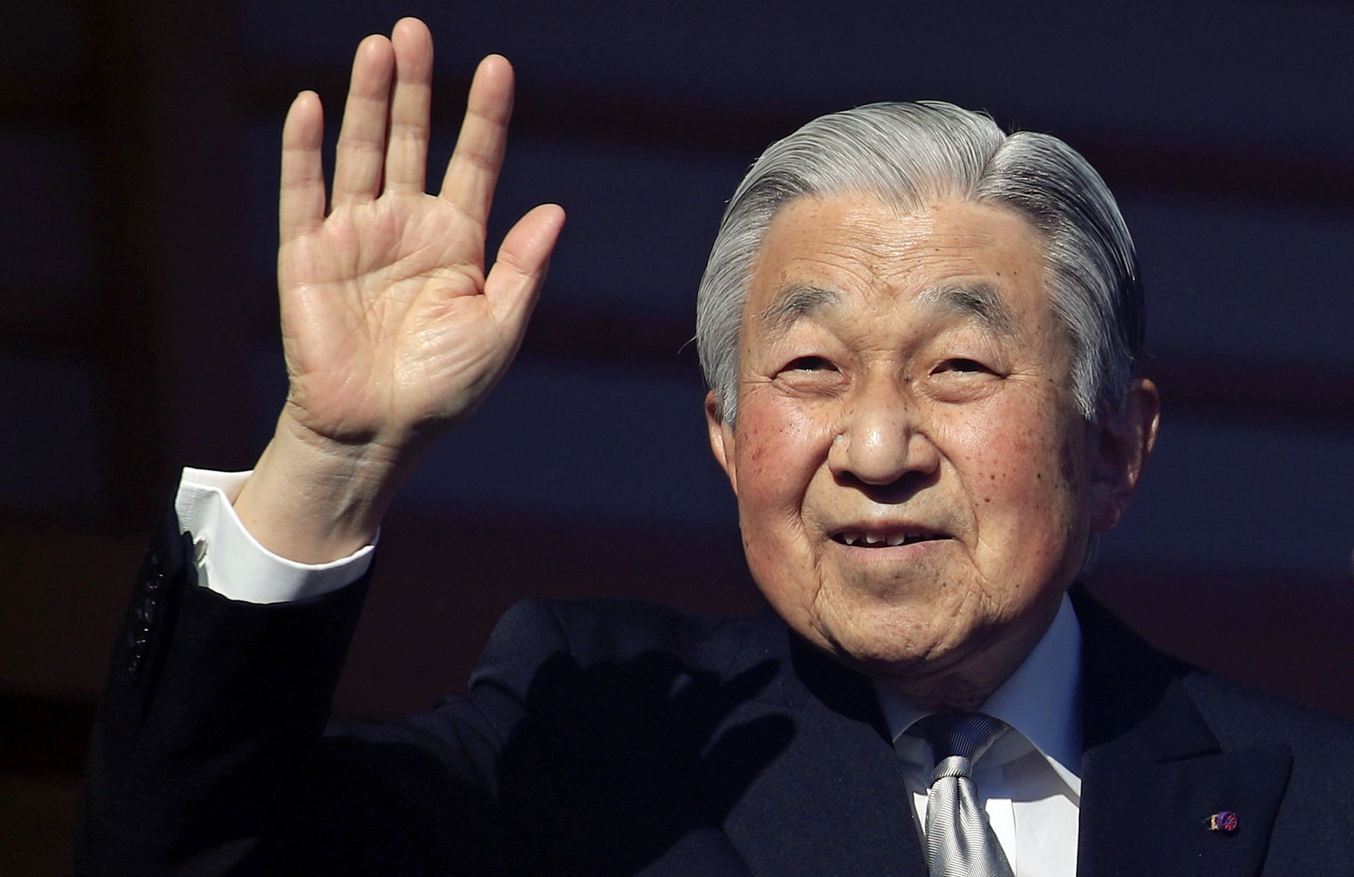 epa07257725 Japan's Emperor Akihito waves to well-wishers through bullet-proof glass from a balcony during his New Year's public appearance at the Imperial Palace in central Tokyo, Japan, 02 January 2019. Emperor Akihito will abdicate on 30 April 2019.  EPA/FRANCK ROBICHON