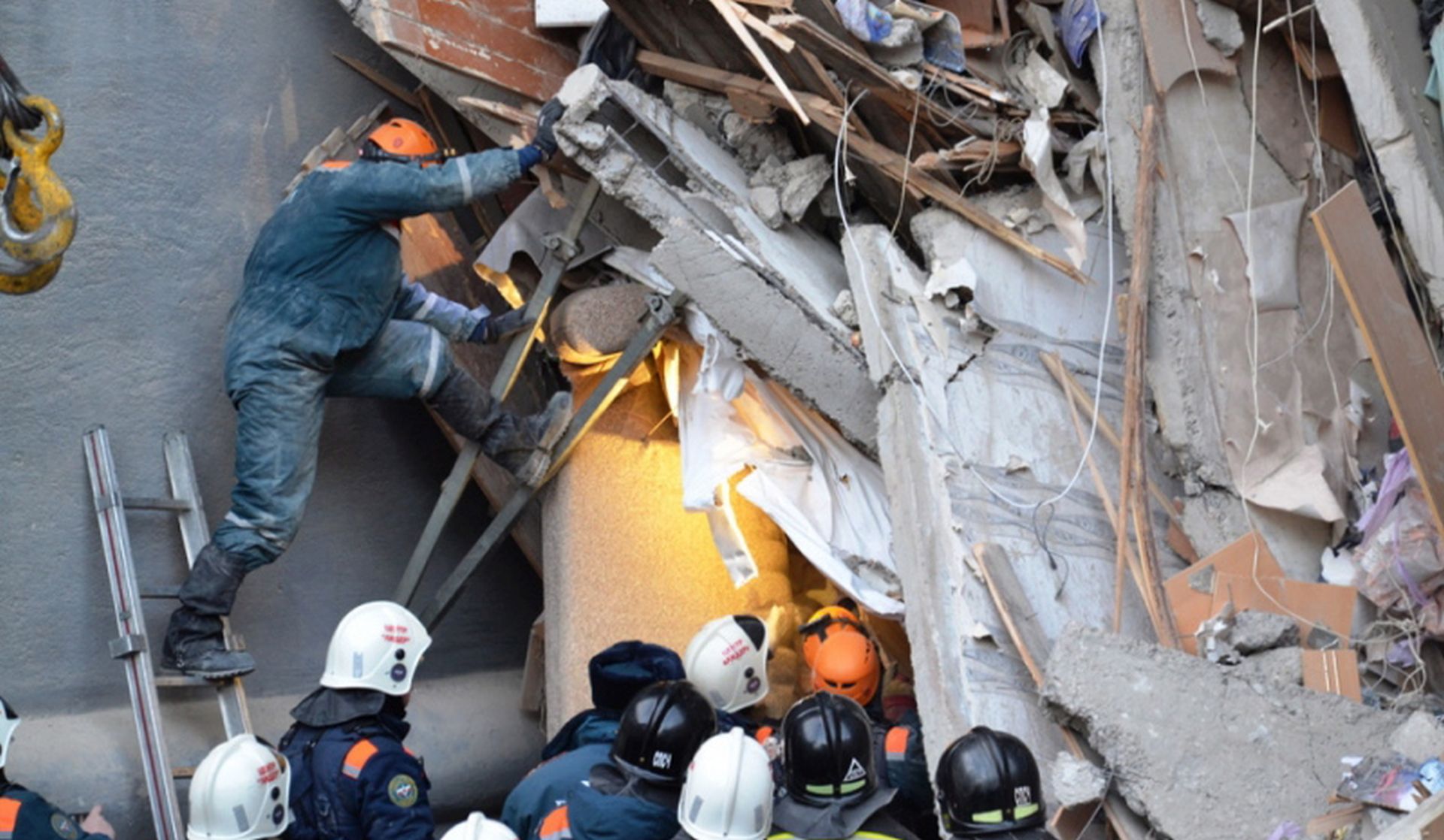 epa07258046 A handout photo made available by the Russian Emergency Situations Ministry Chelyabinsk Region shows Russian rescue workers clearing debris after a gas explosion in an apartment building in the city of Magnitogorsk, Chelyabinsk region, Russia, 02 January 2019. The explosion in a residential building in Magnitogorsk damaged 48 apartments, in which reportedly 110 people lived. Sixteen people were confirmed to have died and the fate of 25 is still unknown. A ten month child was found alive but in a serious condition.  EPA/EMERGENCY SITUATIONS MINISTRY / HANDOUT BEST QUALITY AVAILABLE HANDOUT EDITORIAL USE ONLY/NO SALES