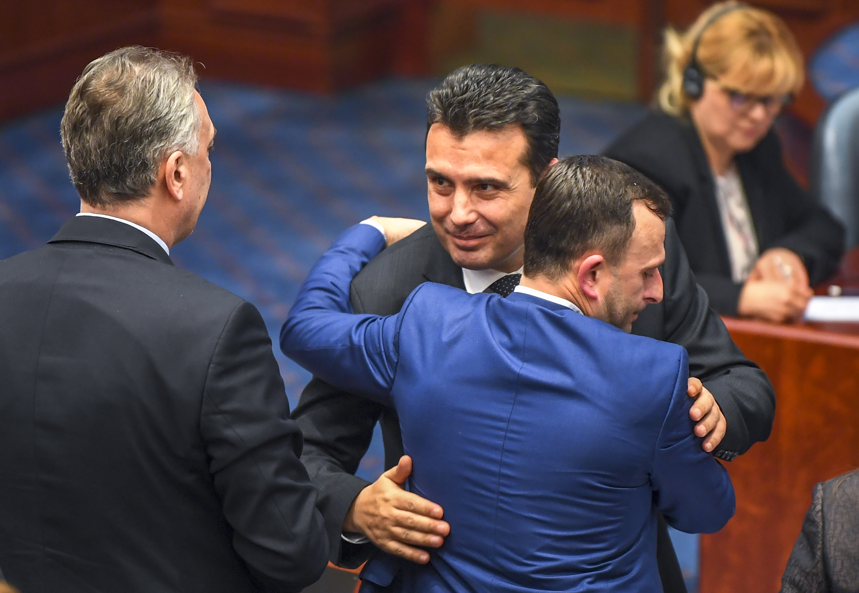epa07276017 Former Yugoslav Republic of Macedonia (FYROM) Prime Minister Zoran Zaev (C) hugs a lawmaker after the members of the Parliament, in Skopje, The Former Yugoslav Republic of Macedonia, 11 January 2019 voted to change constitution and change the country name to North Macedonia. The agreement with Greece is key for Macedonia's NATO and EU accession process.  EPA/GEORGI LICOVSKI