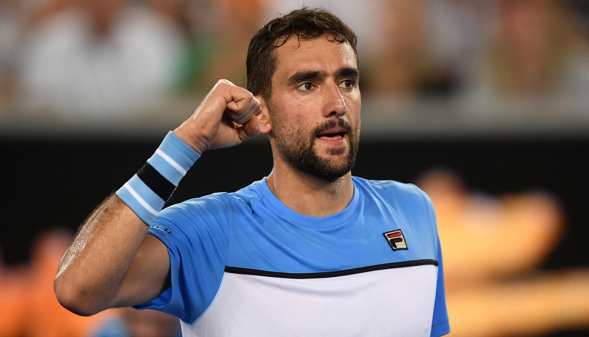 epa07282695 Marin Cilic of Croatia celebrates winning his men's singles first round against Bernard Tomic of Australia at the Australian Open tennis tournament in Melbourne, Australia, 14 January 2019.  EPA/LUKAS COCH AUSTRALIA AND NEW ZEALAND OUT