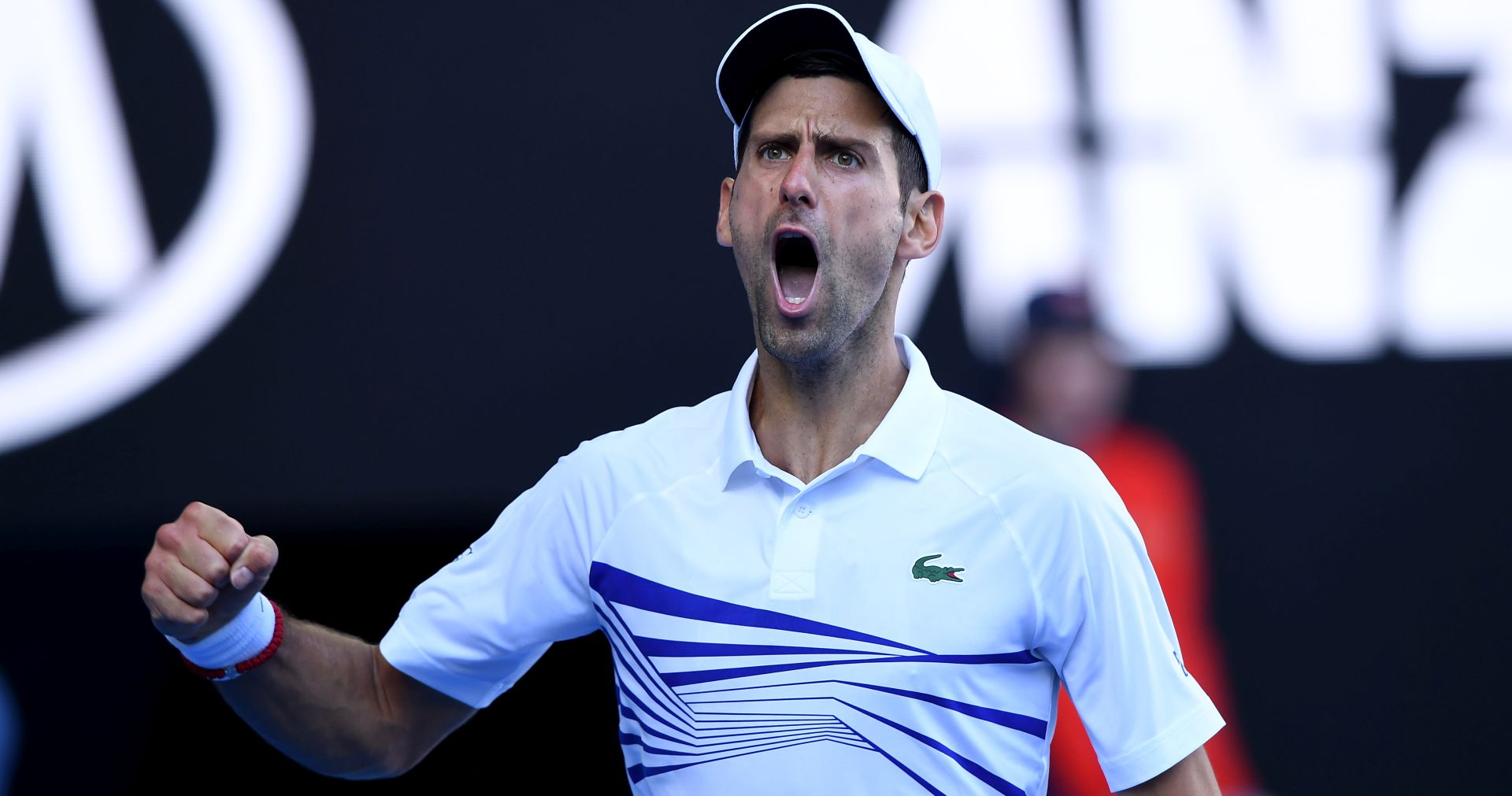 epa07298802 Novak Djokovic of Serbia reacts while in action against Denis Shapovalov of Canada during their round three men's singles match at the Australian Open Grand Slam tennis tournament in Melbourne, Australia, 19 January 2019.  EPA/JULIAN SMITH AUSTRALIA AND NEW ZEALAND OUT