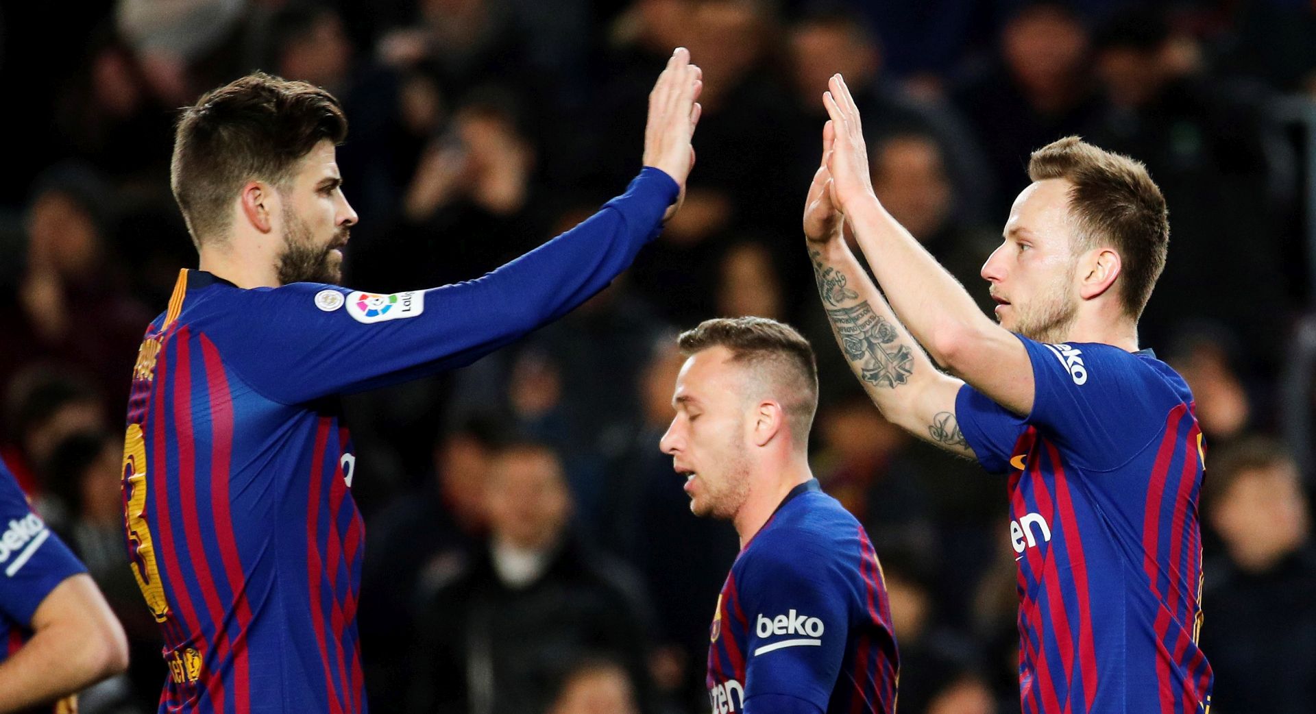 epa07332467 FC Barcelona's midfielder Ivan Rakitic (R) celebrates with his teammate Gerard Pique (L) after scoring the 2-0 during the Spanish King's Cup quarter final second leg match between FC Barcelona and Sevilla FC at Camp Nou stadium in Seville, Andalusia, Spain, 30 January 2019.  EPA/Alejandro Garcia