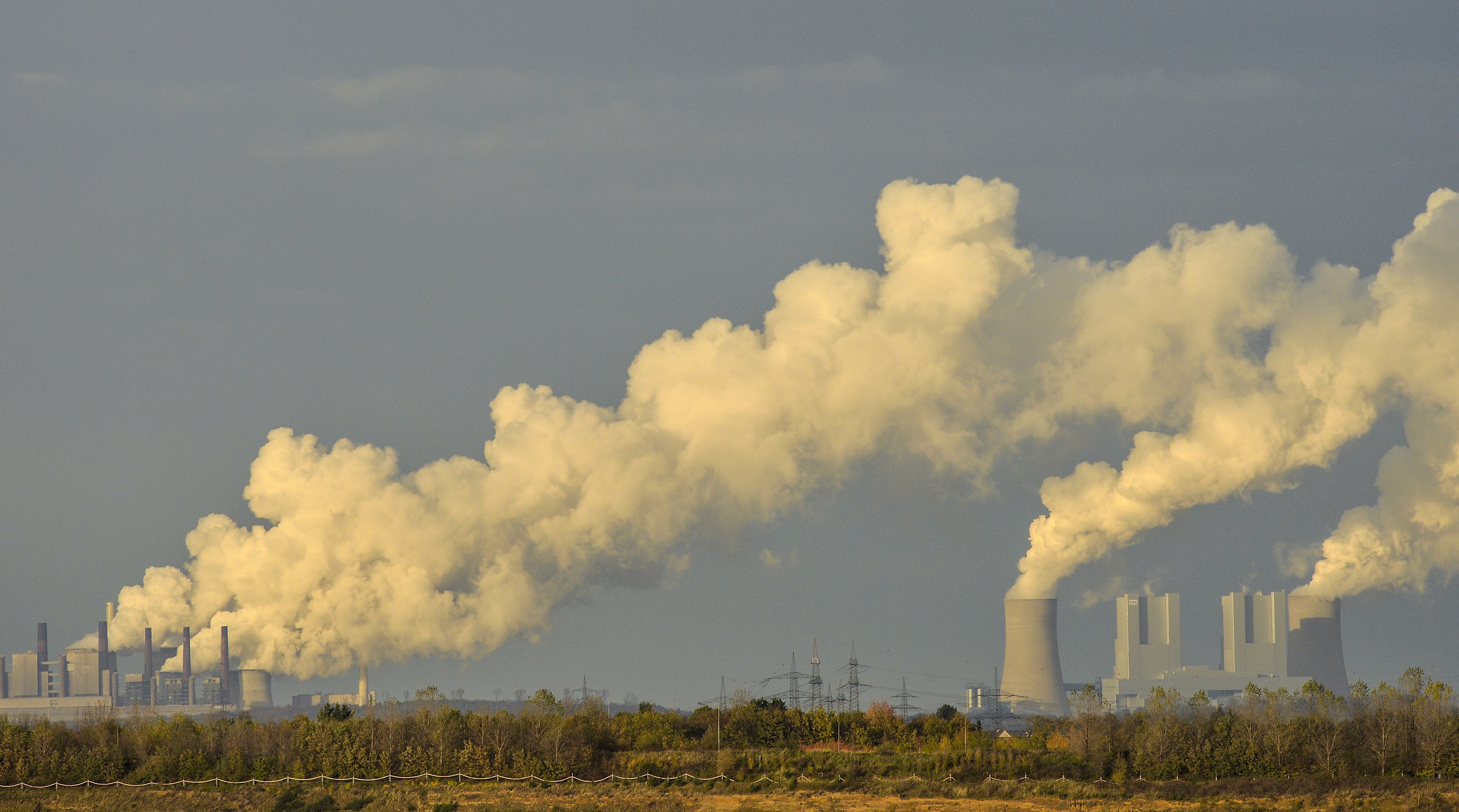 epa07320687 (FILE) - Coal power plants Neurath (L) and Niederaussem (R) produce steam near the Hambach opencast mining in the Rhineland during protests prior to the UN Climate Change Conference COP23 in Bonn, Germany, 05 November 2017 (reissued 26 January 2019). Germany's Structural Commission (Kohlekommission), appointed by Chancellor Angela Merkel, recommends the country should quit coal latest by 2038 in order to meet its emissions targets. The proposal, released on 26 January 2019, is subject to amendment by government and parliament, media reported.  EPA/PHILIPP GUELLAND *** Local Caption *** 53877425