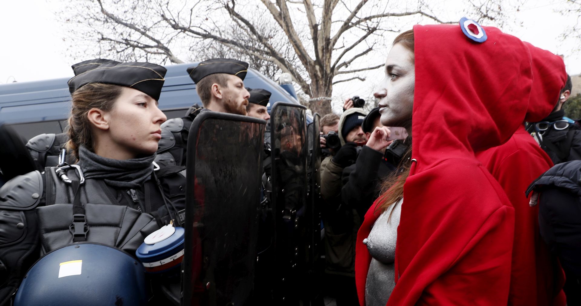 epa07232663 A group of women, dressed in reference to France's emblematic Marianne figure (a personification of liberty and reason), face a line of police officers during a Yellow Vest demonstration in Paris, France, 15 December 2018. The so-called 'gilets jaunes' (yellow vests) is a protest movement, which reportedly has no political affiliation, that continues protests across the nation over high fuel prices.  EPA/ETIENNE LAURENT ATTENTION EDITORS: IMAGE CONTAINS NUDITY