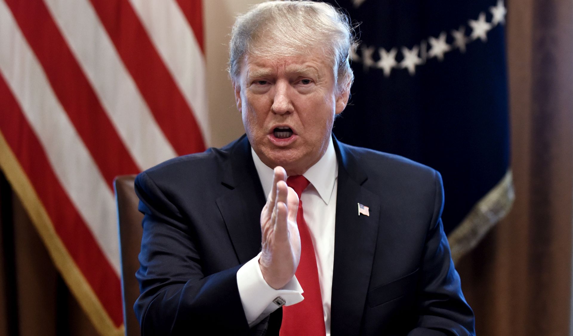 epa07336898 US President Donald J. Trump gestures during a meeting to discuss fighting human trafficking on the southern border in the Cabinet Room of the White House in Washington, DC, USA, 01 February 2019.  EPA/OLIVIER DOULIERY