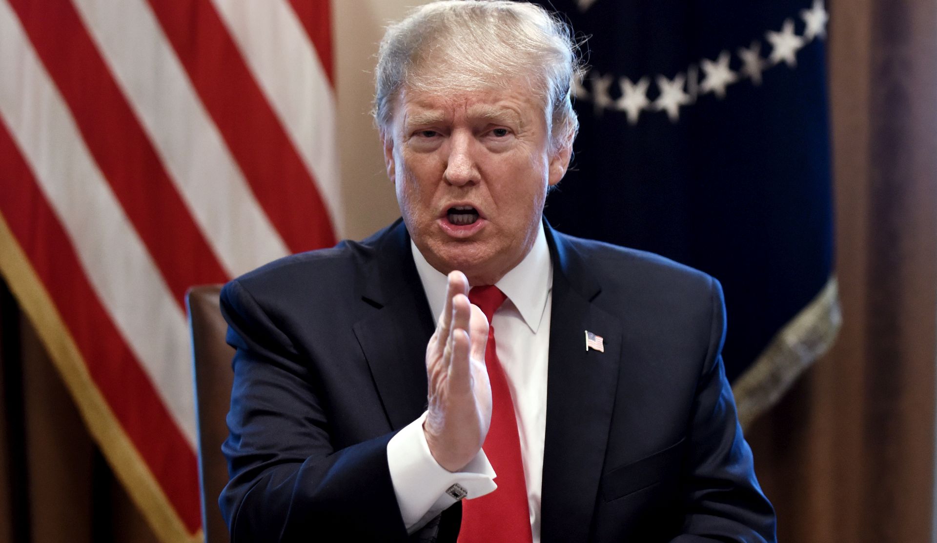 epa07336898 US President Donald J. Trump gestures during a meeting to discuss fighting human trafficking on the southern border in the Cabinet Room of the White House in Washington, DC, USA, 01 February 2019.  EPA/OLIVIER DOULIERY