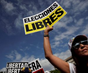 epa07339763 A woman holds a sign that reads 'Free election' during a rally to show support to President of the Venezuelan National Assembly Juan Guaido and protest against the crisis in their country, in Panama City, Panama, 02 February 2019. Venezuela's President Maduro and his opponent National Assembly leader Juan Guaido have called on their supporters to take to the streets as international pressure increased on Maduro to resign. Guiado had declared himself interim president of Venezuela on 23 January and promised to guide the country toward new election as he consider last May's election not valid.  EPA/Bienvenido Velasco